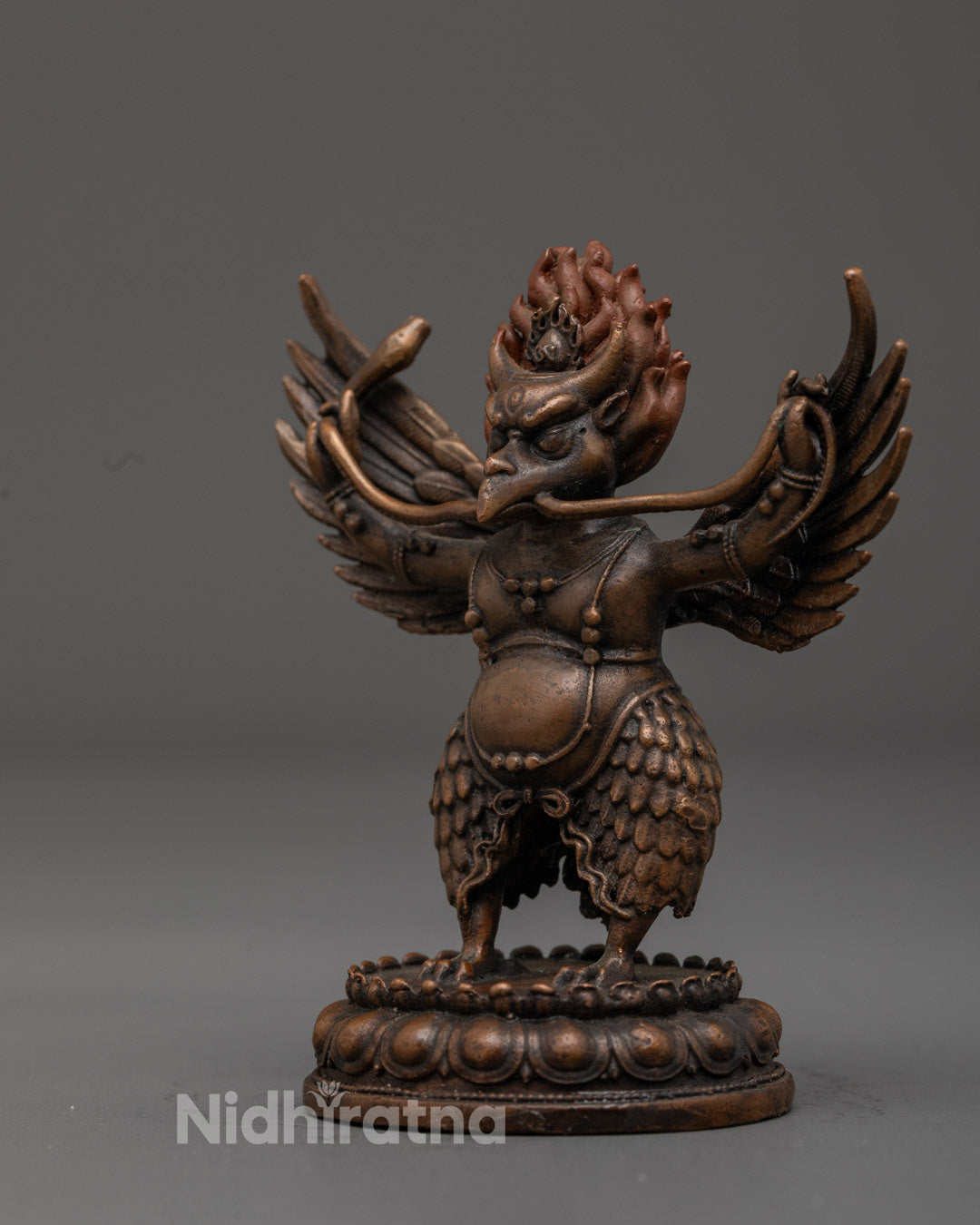 Garuda deity seated on a lotus throne symbolizing purity and spiritual awakening