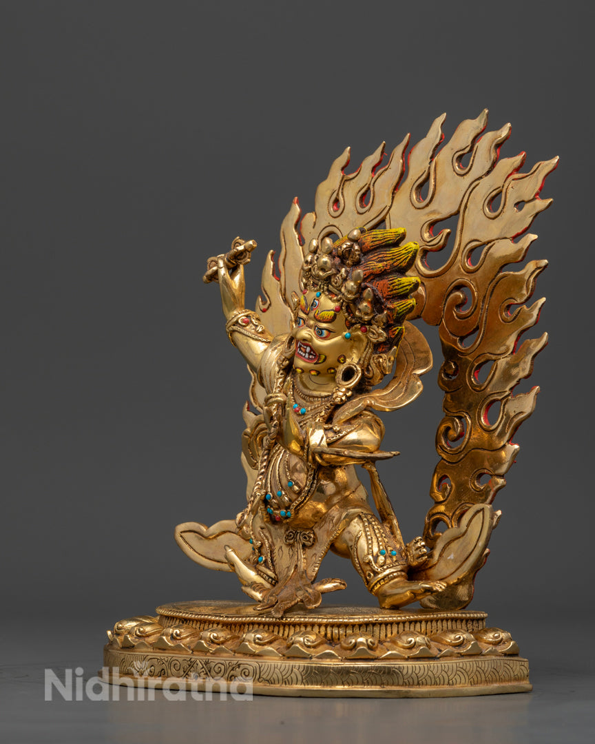 side view of gold plated vajrapani statue with copper base