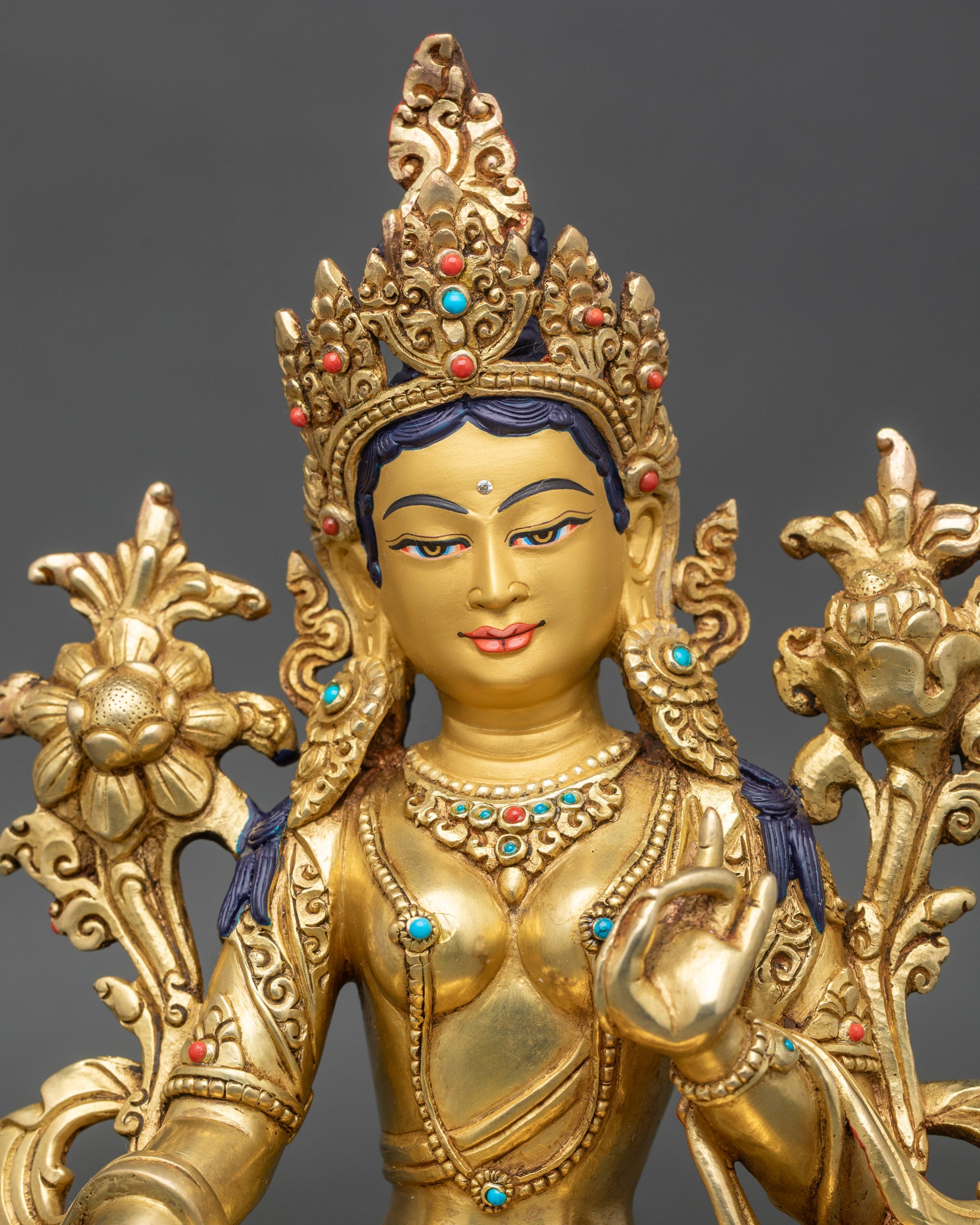 Golden-painted Green Tara face with serene expression and ornate crown headdress