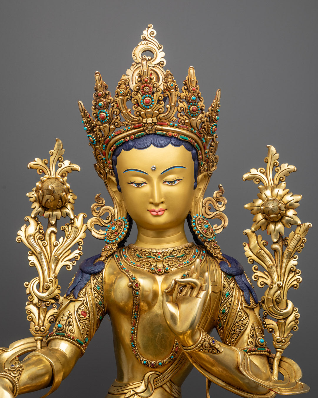 Green Tara’s serene face and upper body, showcasing her compassionate expression, flowing robes, and symbolic hand gestures