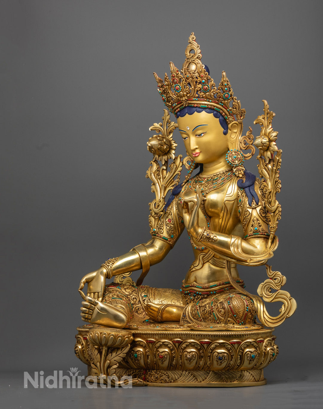 Green Tara statue set against a neutral background, capturing her poised stance and the spiritual energy of traditional Nepalese artistry