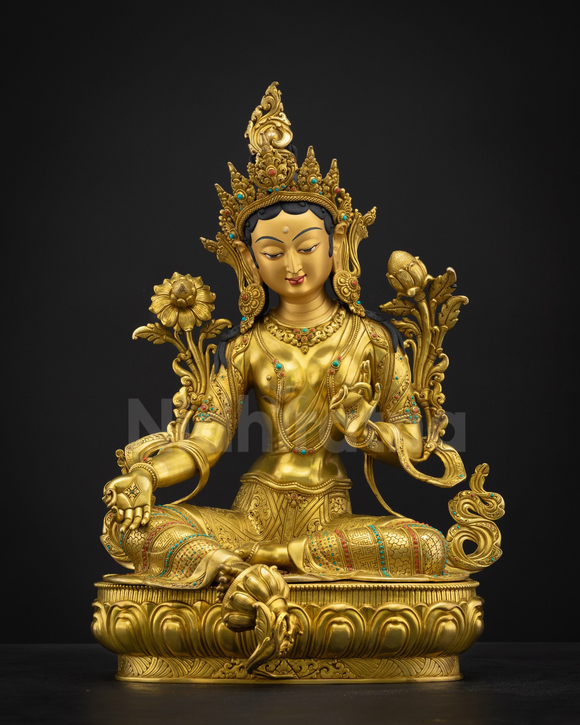 Front view of Green Tara Buddhist statue seated in Lalitasana on a lotus, gold-painted face, semi-precious crown