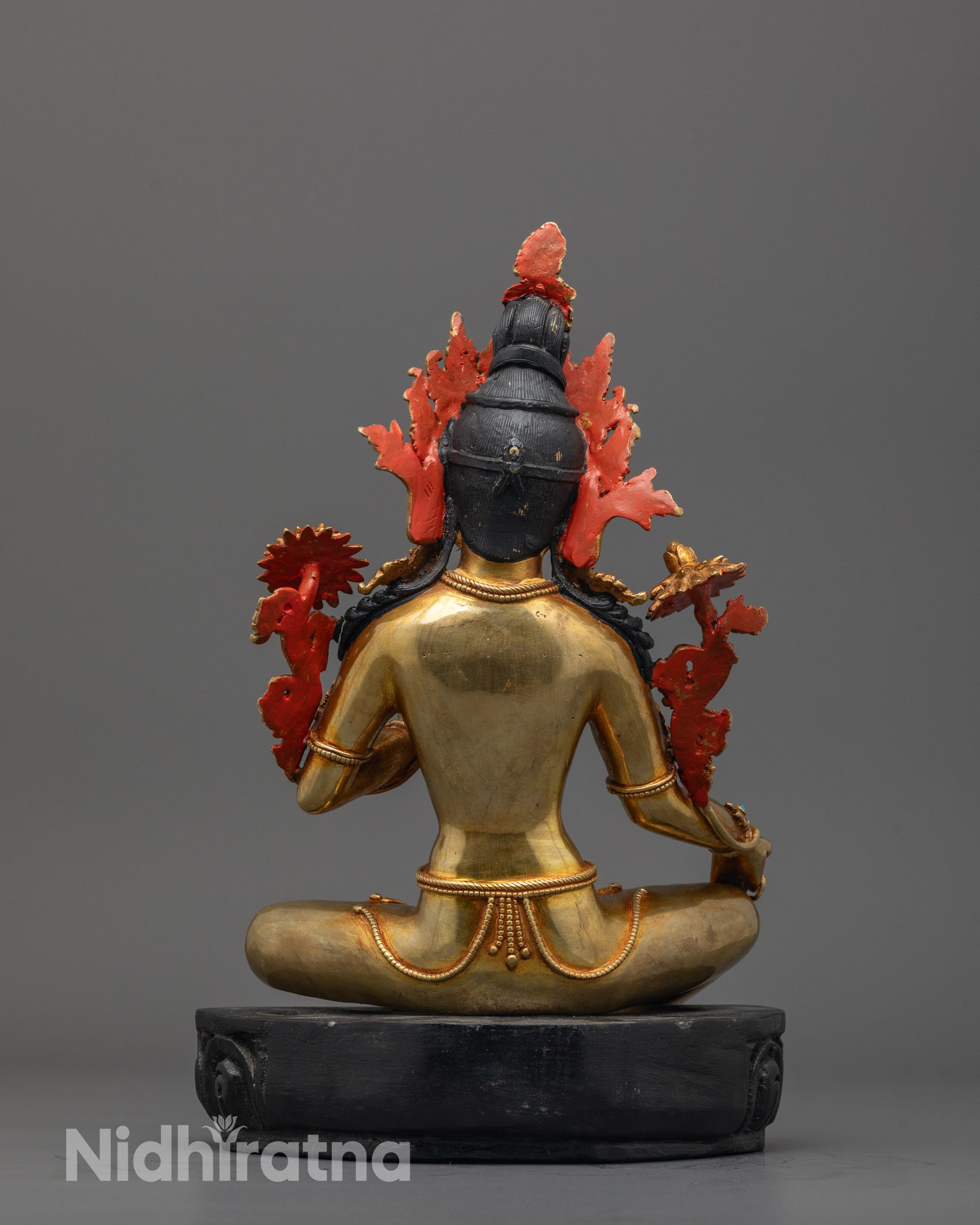 Green Tara Buddhist statue placed on a sacred altar featuring a handcrafted lotus base