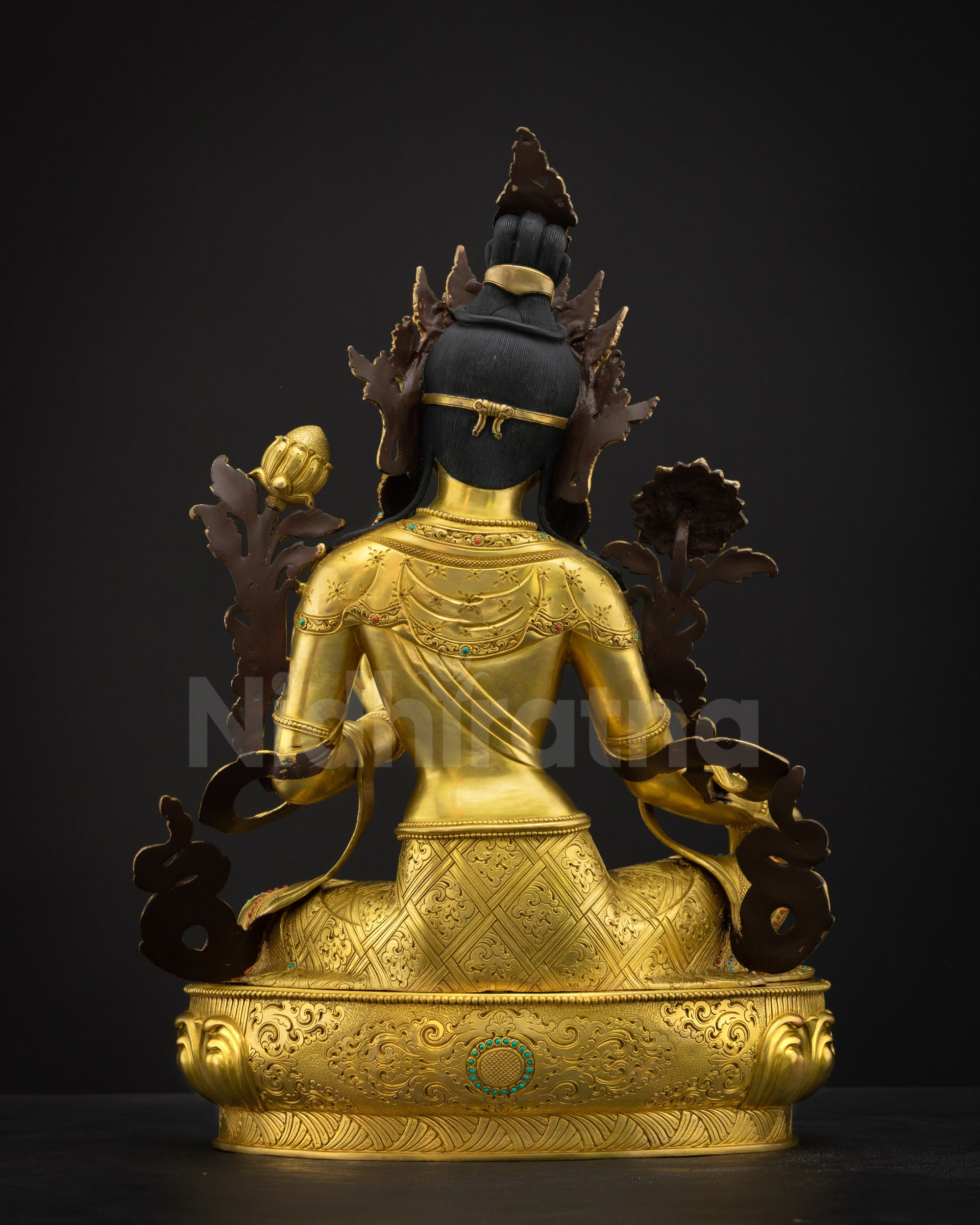 Back view of Green Tara statue showing detailed carvings, gold layers, and polished finish on copper