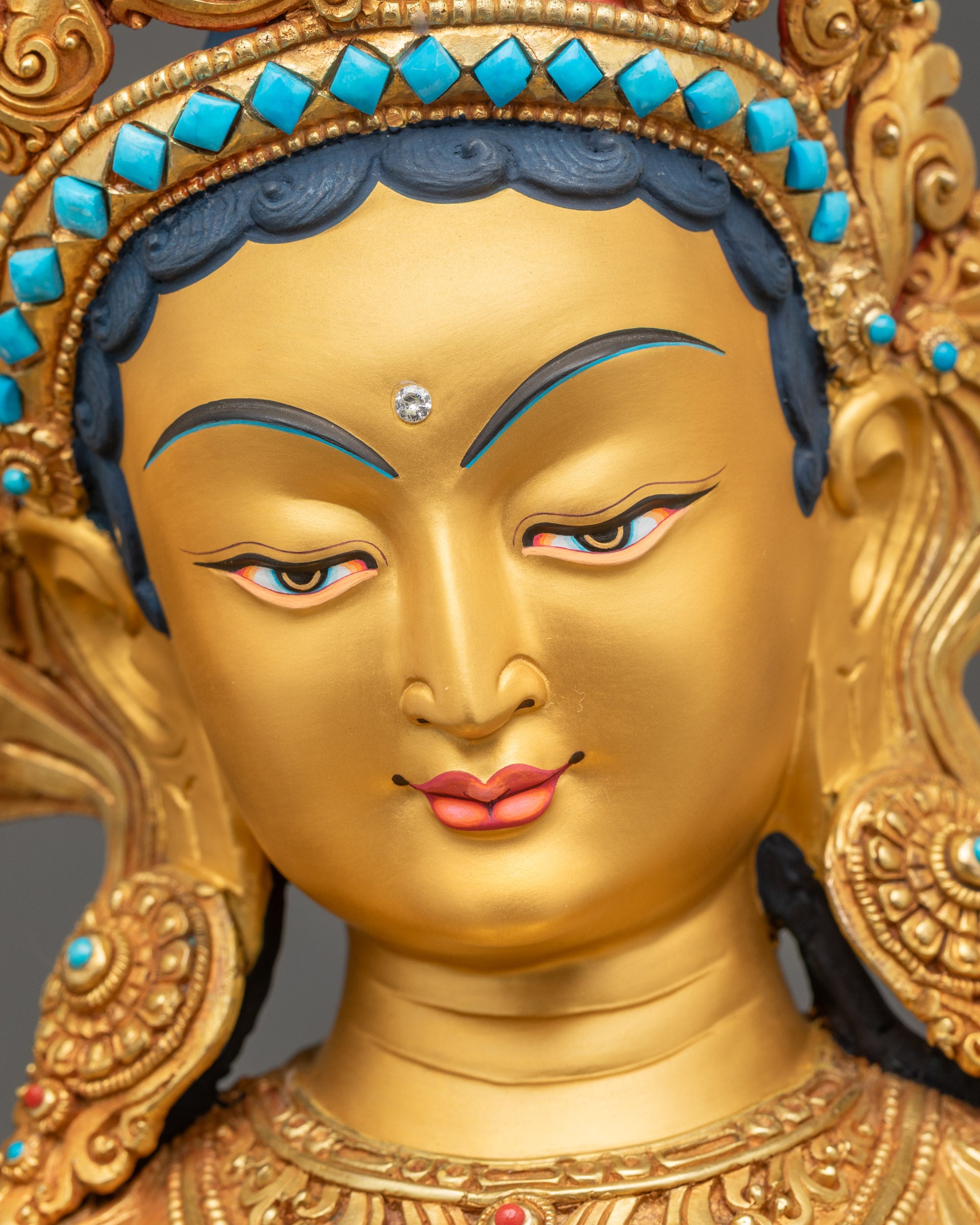 Green Tara Statue close up face serene gold-gilded expression