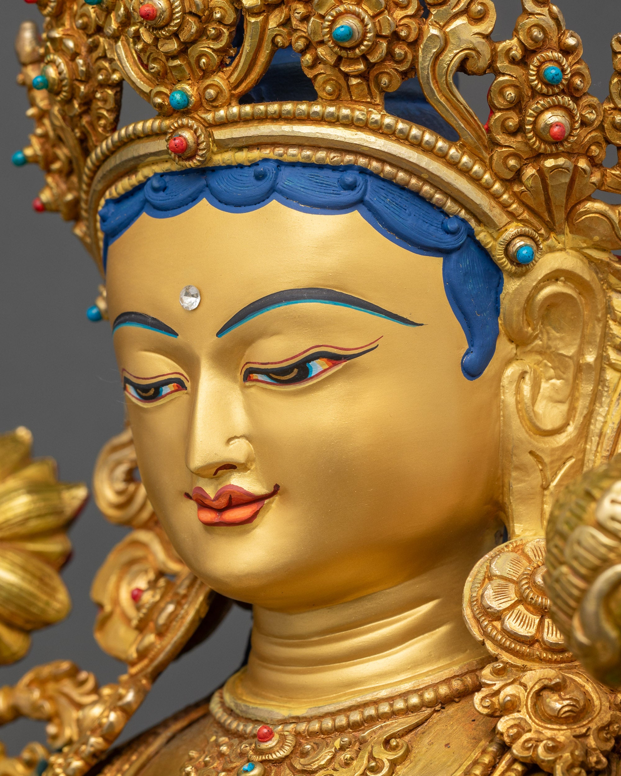 Green Tara Statue side close up serene gold-gilded face and jewelry