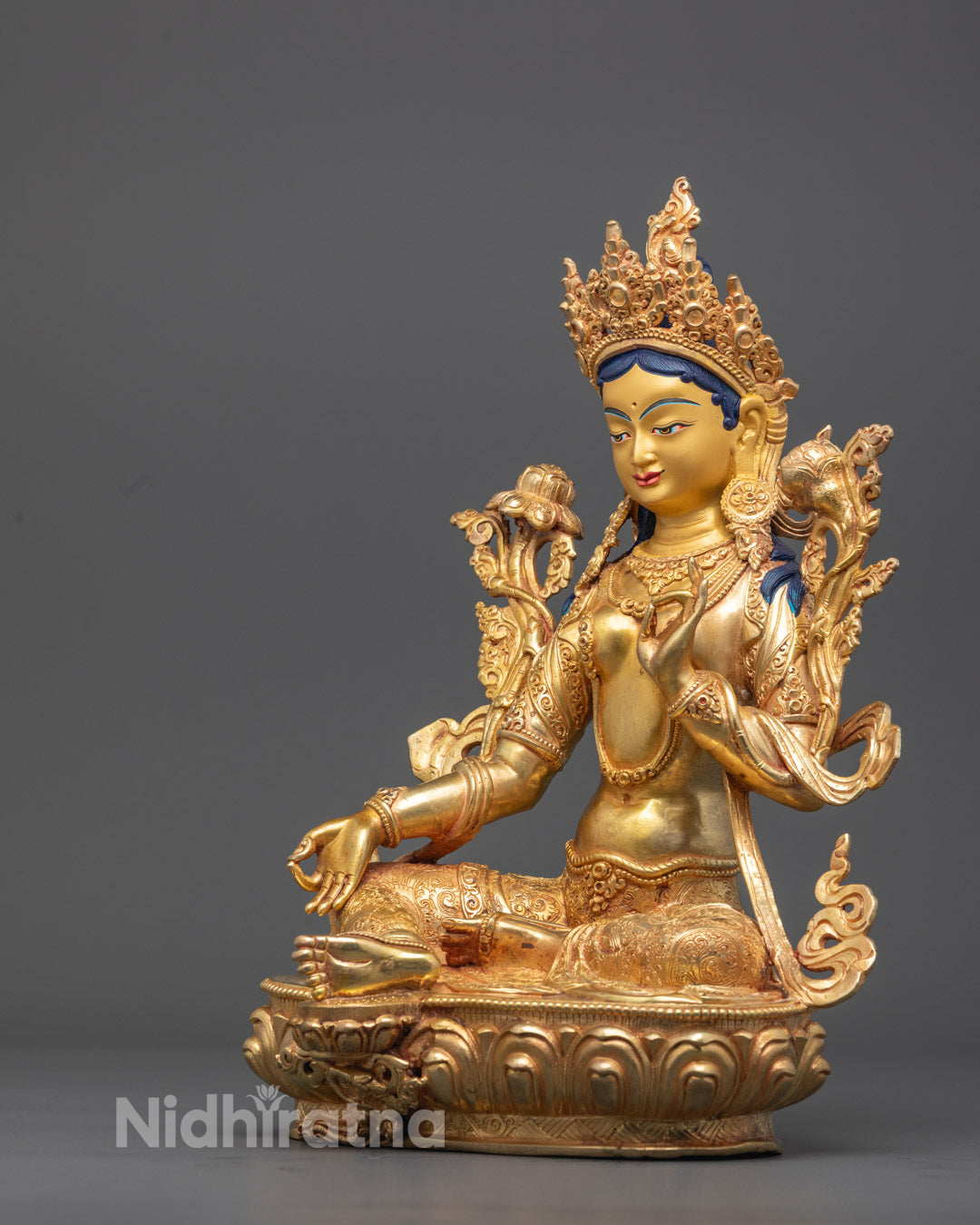 Green Tara’s floating robe, ornate jewelry, and blue utpala flowers – showcasing masterful Nepali artisan work