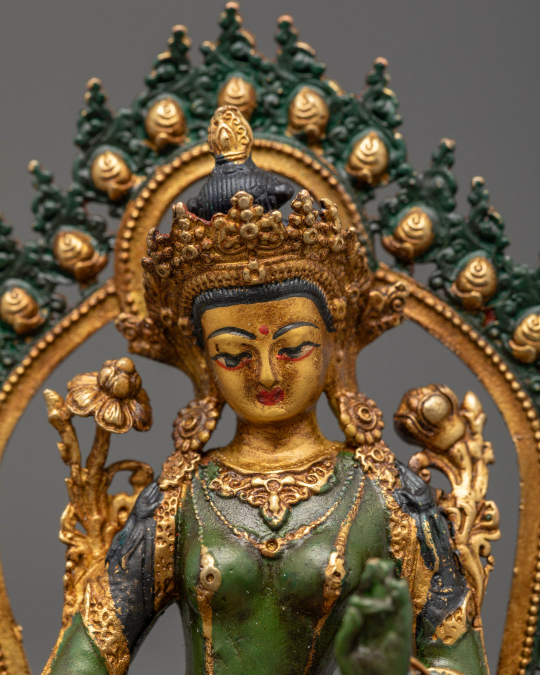 Green Tara statue featuring detailed crown jewelry and robe with rich acrylic colors and gold accents