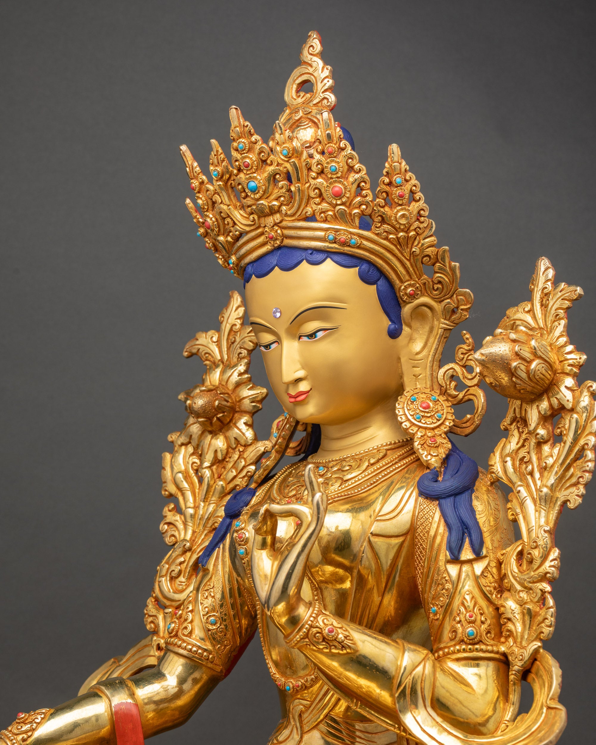 Green Tara statue side close up highlighting intricate 3D carved details