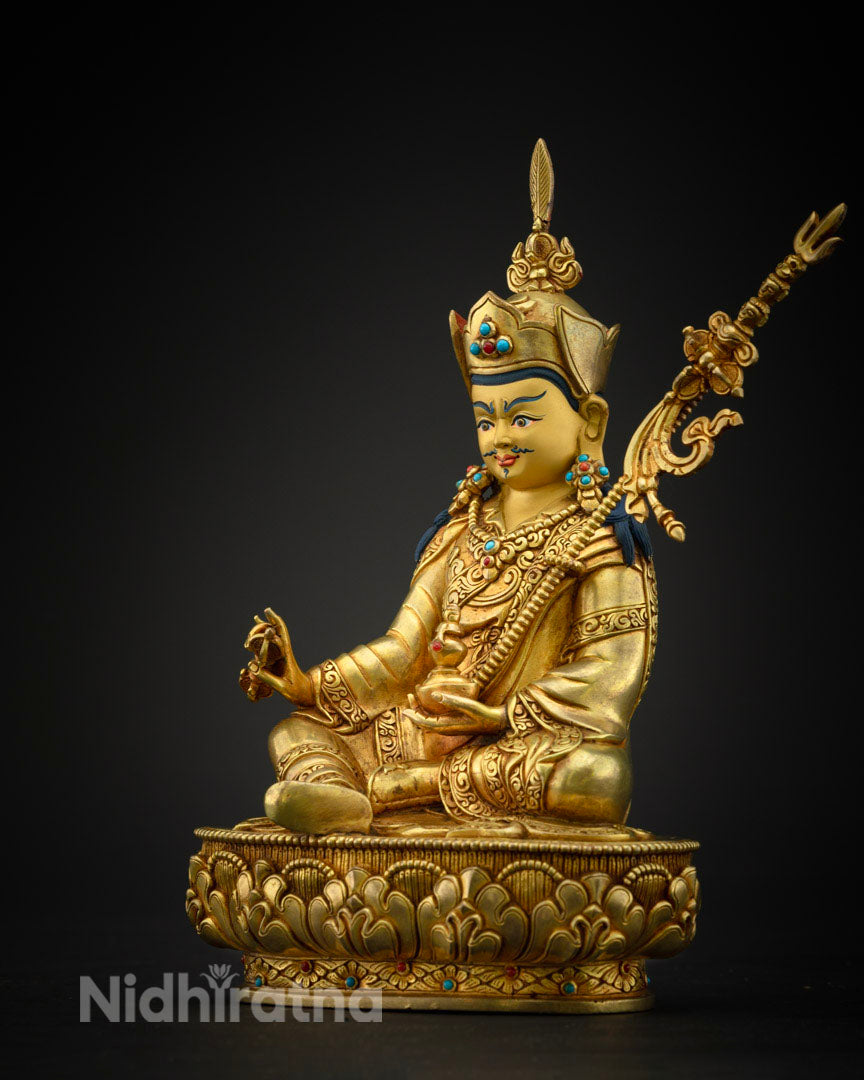 Padmasambhava statue showing the khatvanga staff with three skulls symbolizing transformation of the three poisons.