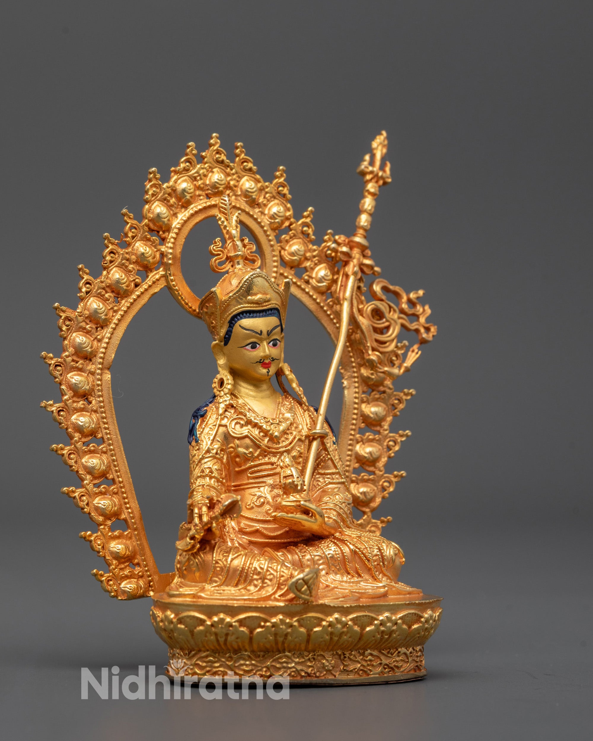 Side view of machine-made Guru Rinpoche statue showing intricate gold finish