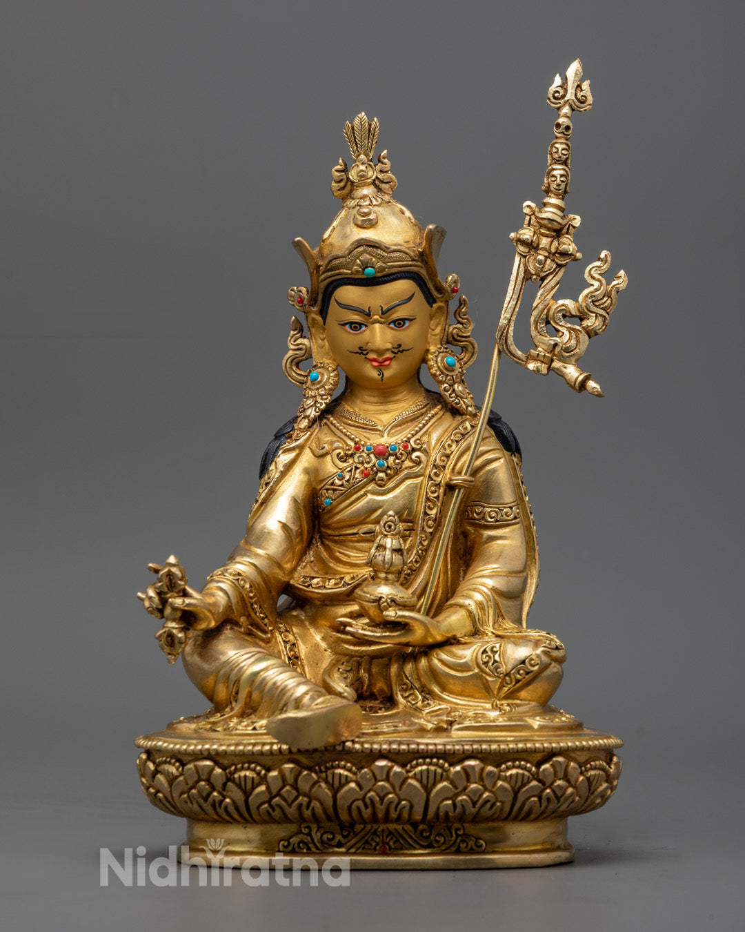 Spiritual Guru Rinpoche statue handcrafted with lost wax method and fire-gilded with pure gold on golden copper, perfect to elevate meditation and spiritual practice.