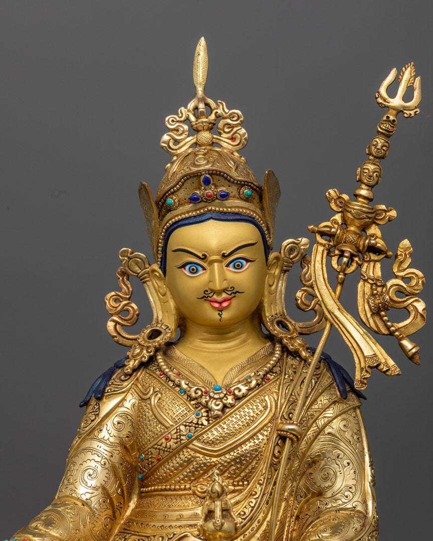 Padmasambhava statue with gold-plated face and vibrant acrylic accents, crafted in Nepal using the traditional lost wax method.