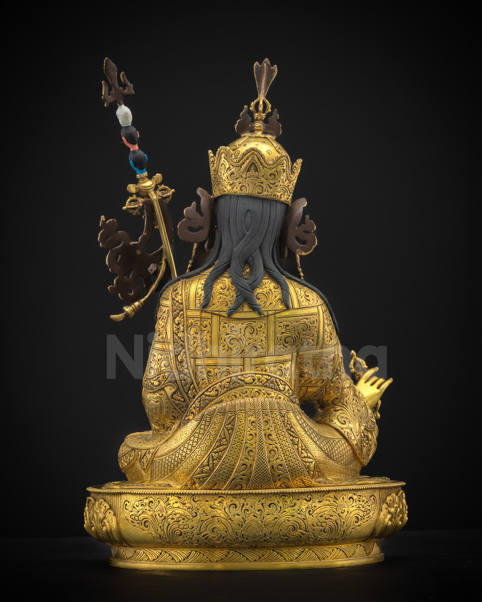 Back view of Guru Rinpoche sculpture showcasing finely carved kasaya robes, lotus throne base, and exquisite Himalayan craftsmanship