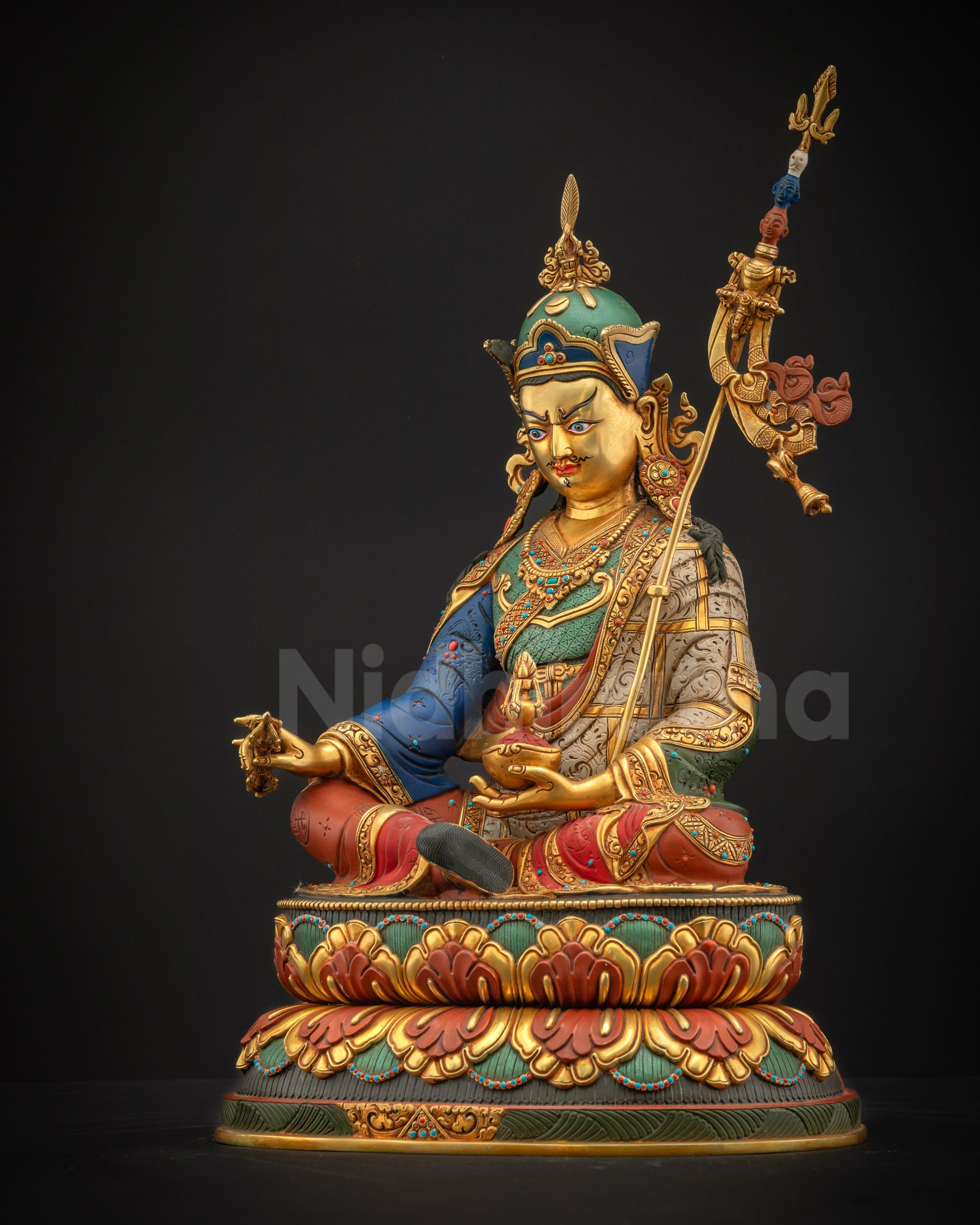 Left-side view of Guru Rinpoche Padmasambhava statue on lotus pedestal holding khatvanga staff, ideal for meditation