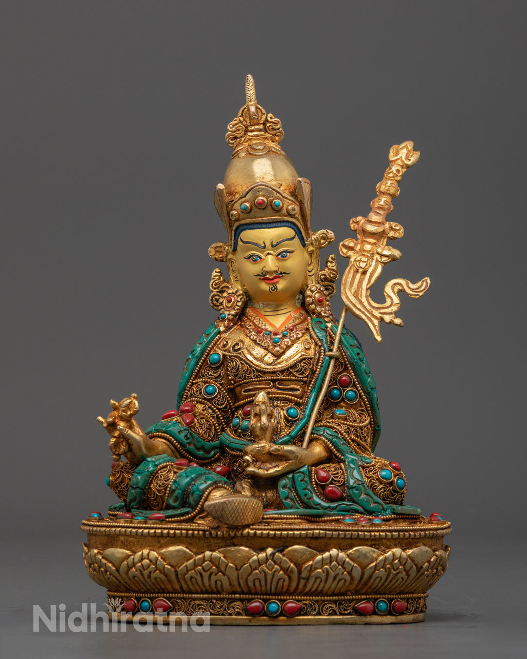 Hand-carved Guru Rinpoche Statue with 24k gold fire gilding and semi-precious stones, crafted using traditional Nepalese lost wax method.