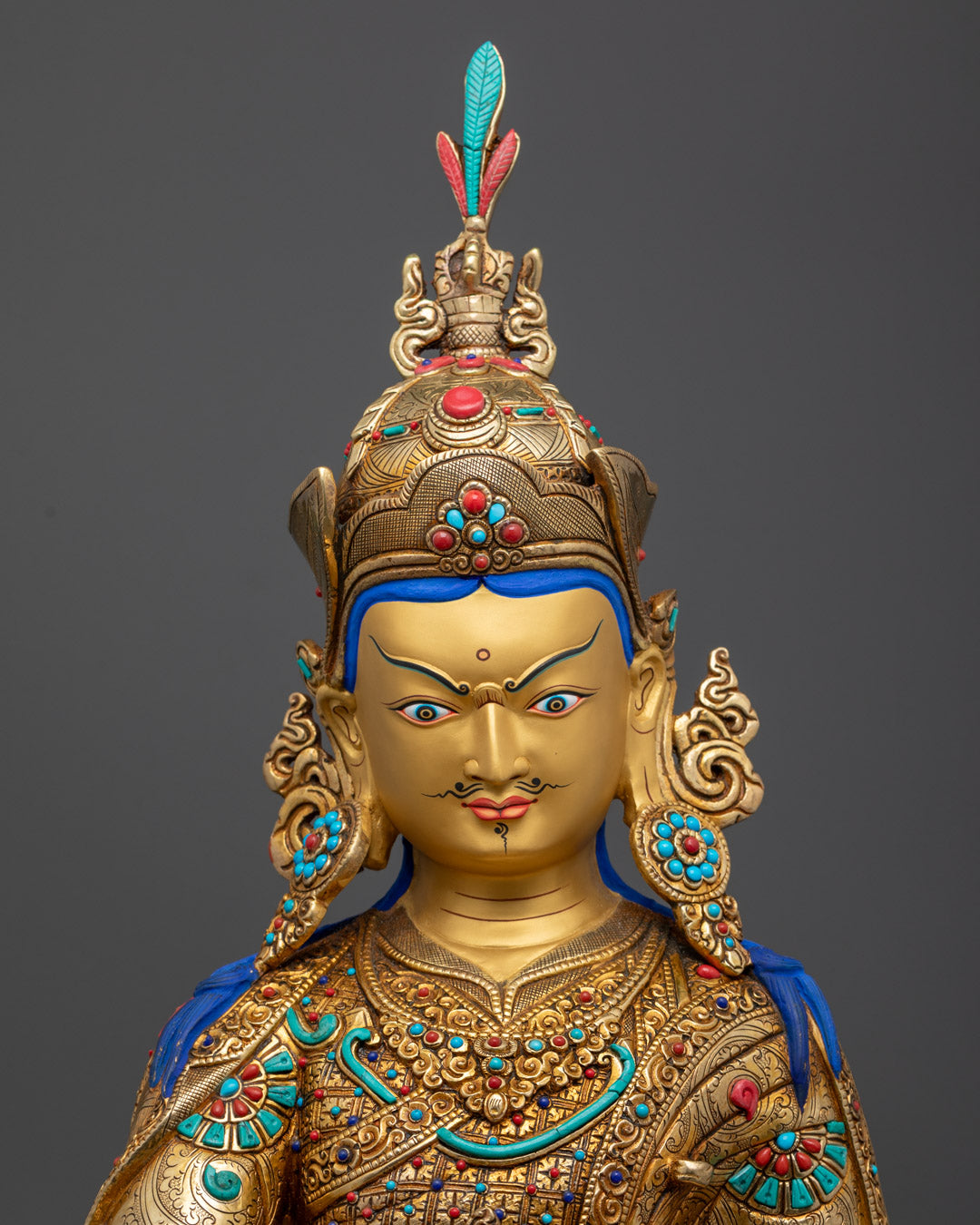 Guru Rinpoche holding a five-pronged vajra and kapala filled with amrita, symbolizing spiritual blessings and nourishment.
