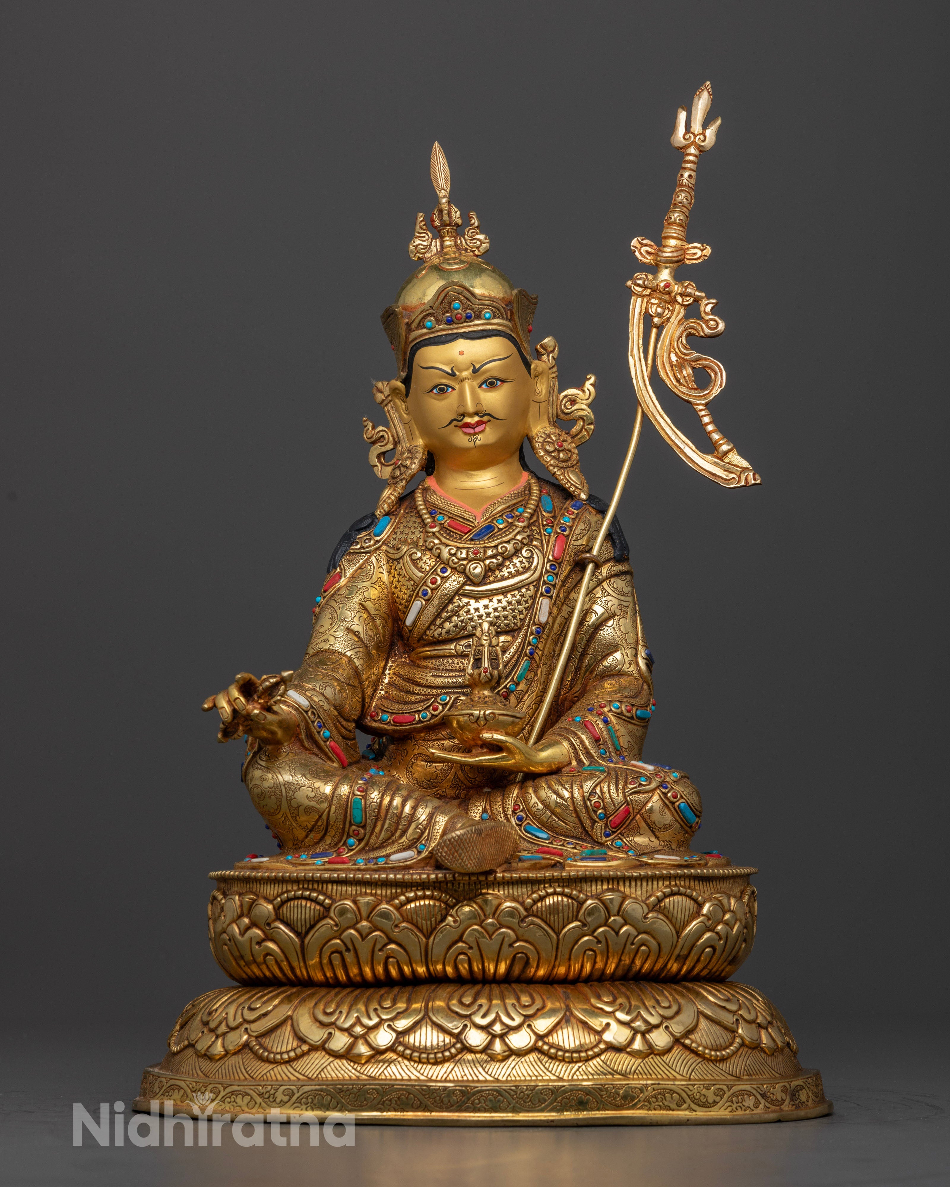 Guru Rinpoche’s hand gestures and ritual implements, capturing the sacred symbolism of protection, guidance, and overcoming obstacles on the spiritual path.