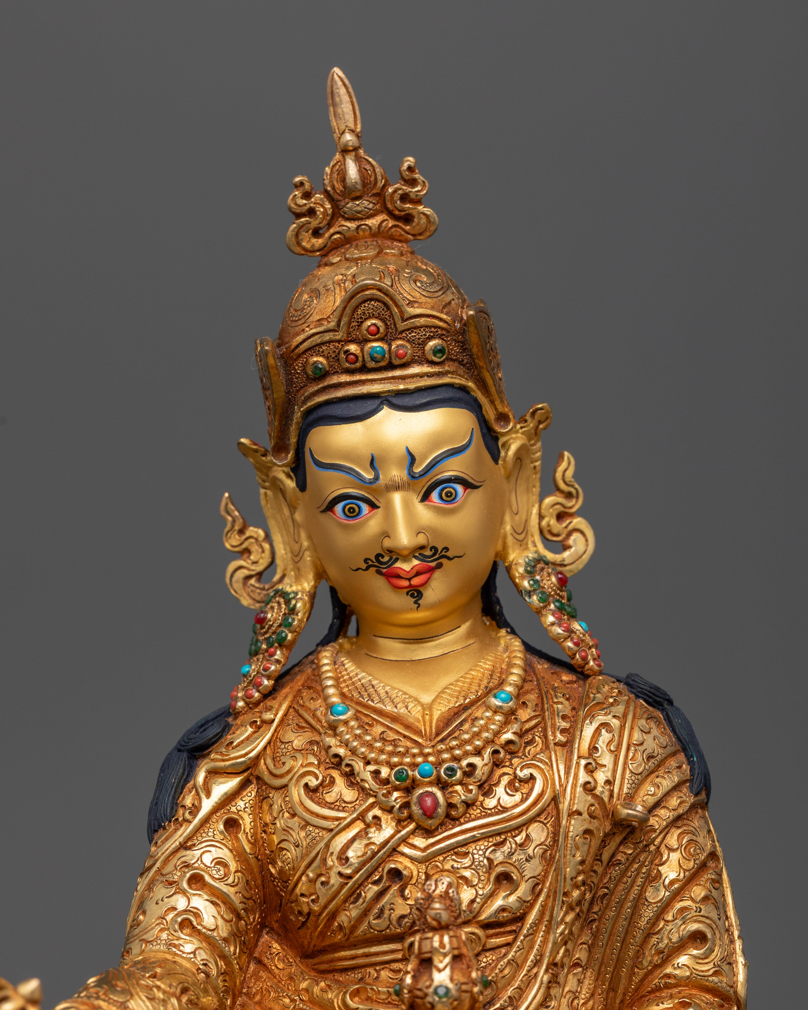 Guru Rinpoche’s serene face, highlighting his mustache, goatee, and expressive eyes—capturing the essence of wisdom, healing, and spiritual power.