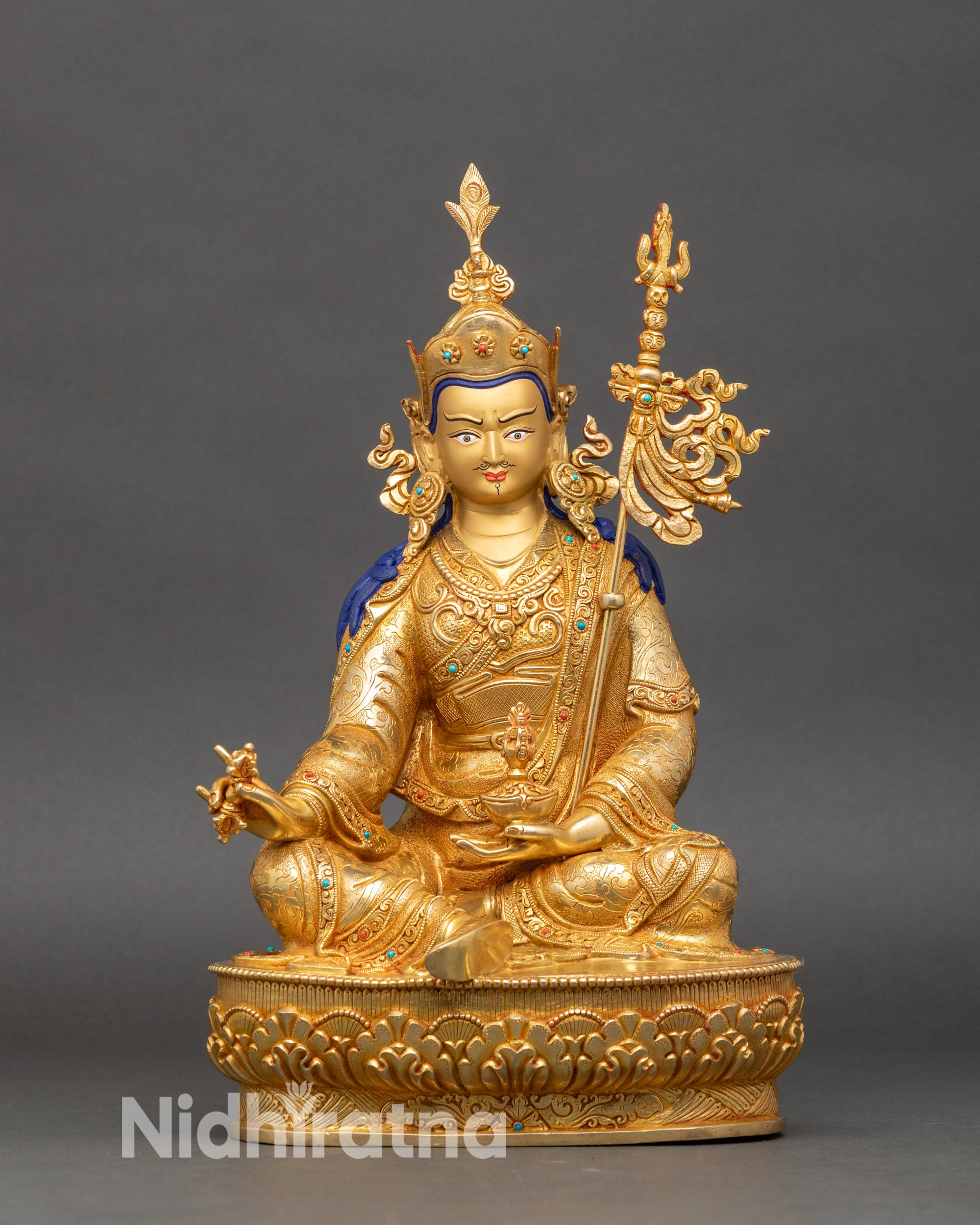 Guru Rinpoche seated statue on lotus pedestal, gold fire-gilded copper, hand-engraved robes