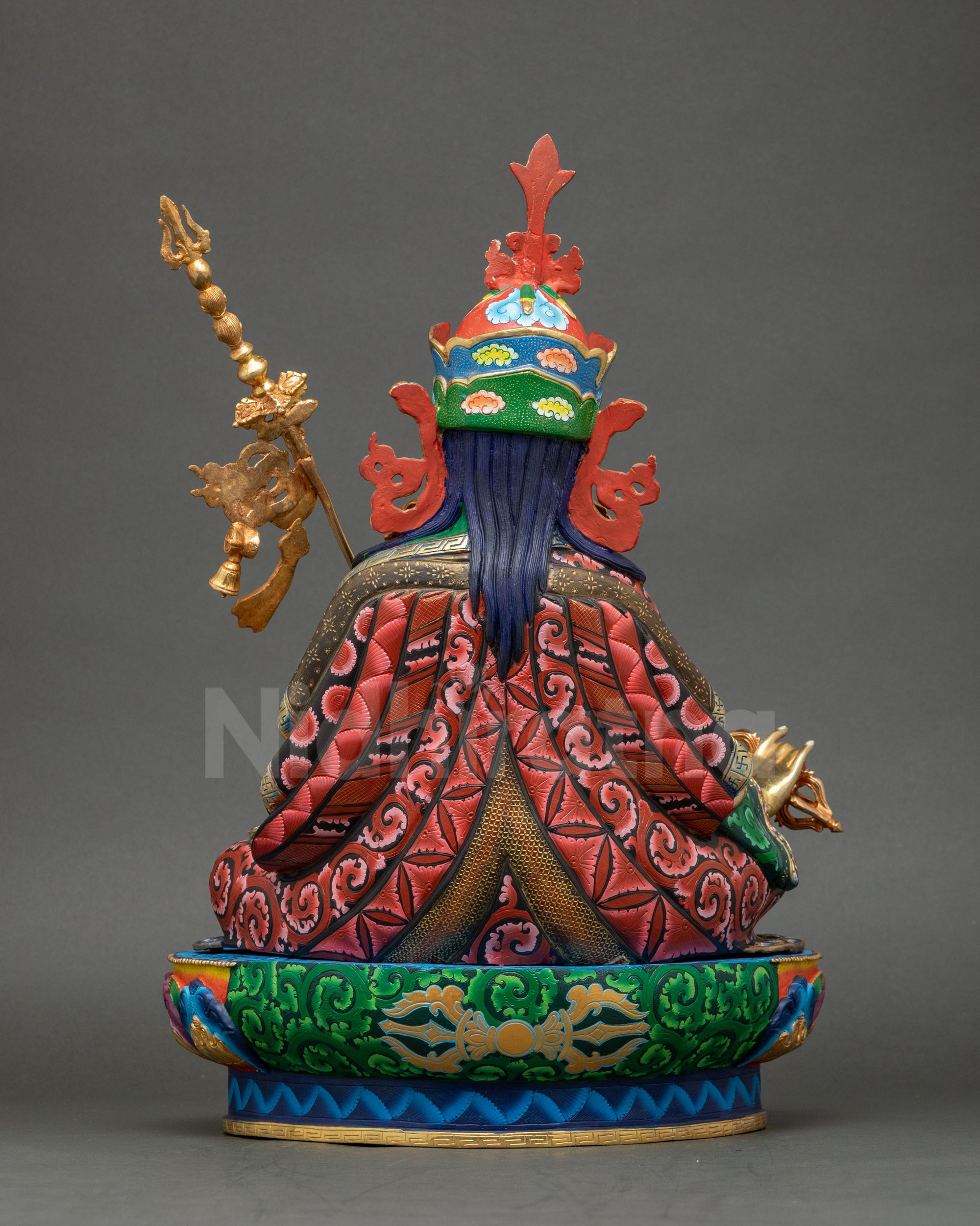 Guru Rinpoche statue back view highlighting carved copper and kasaya folds