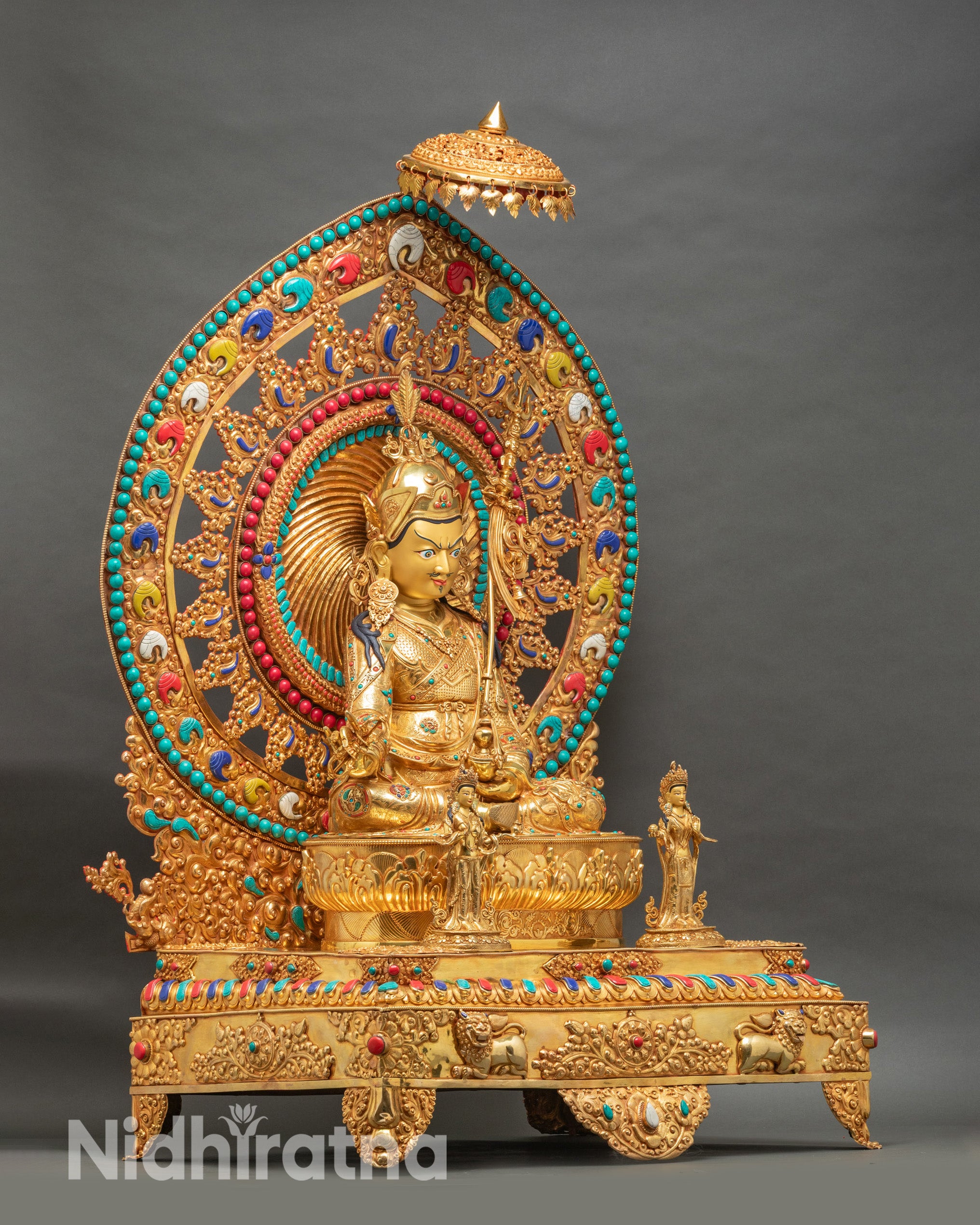 Guru Rinpoche statue from right angle displaying full ornate lion throne with golden framework and gemstone inlays