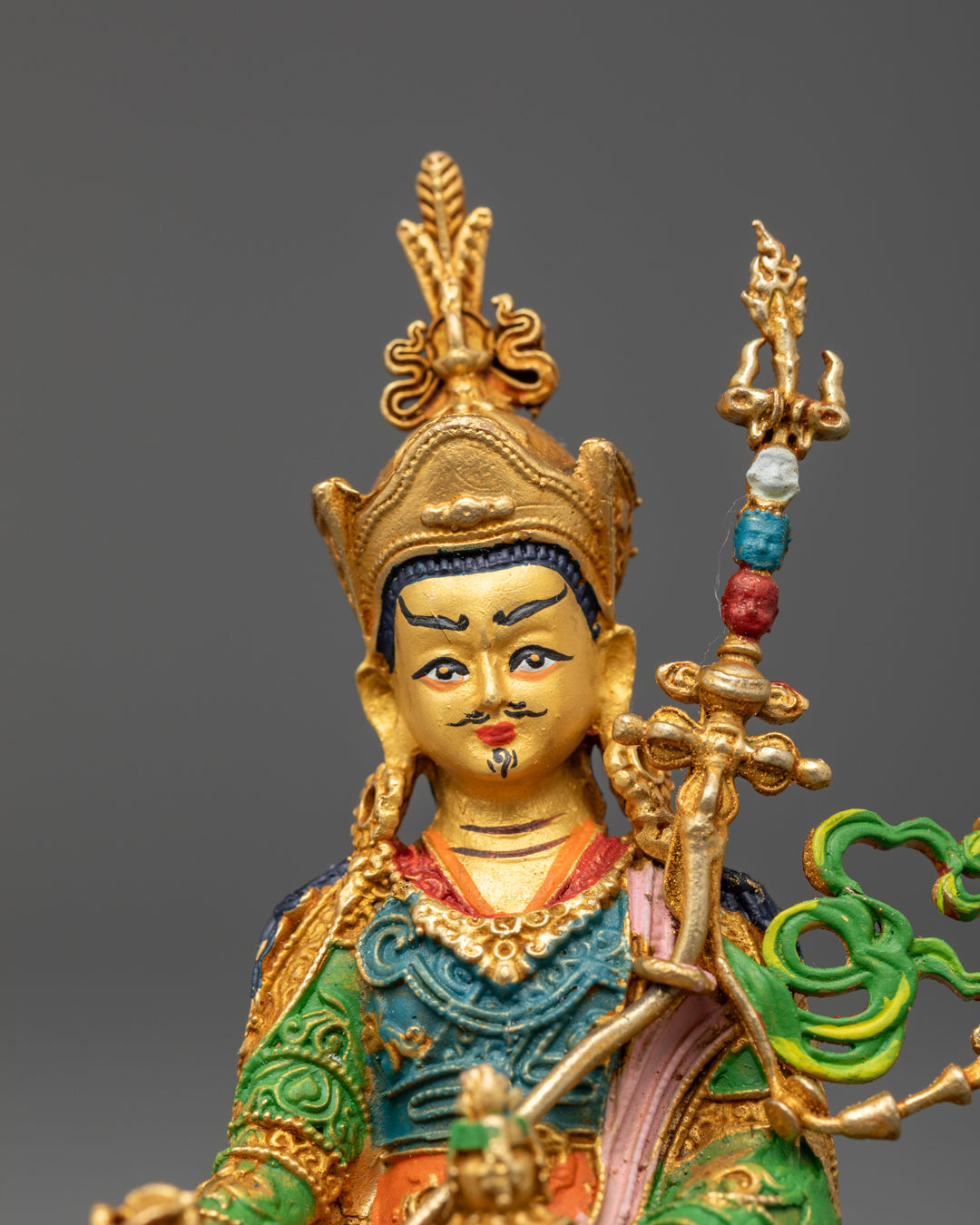 Guru Rinpoche statue’s golden face and acrylic-painted handcrafted look with electroplated copper finish