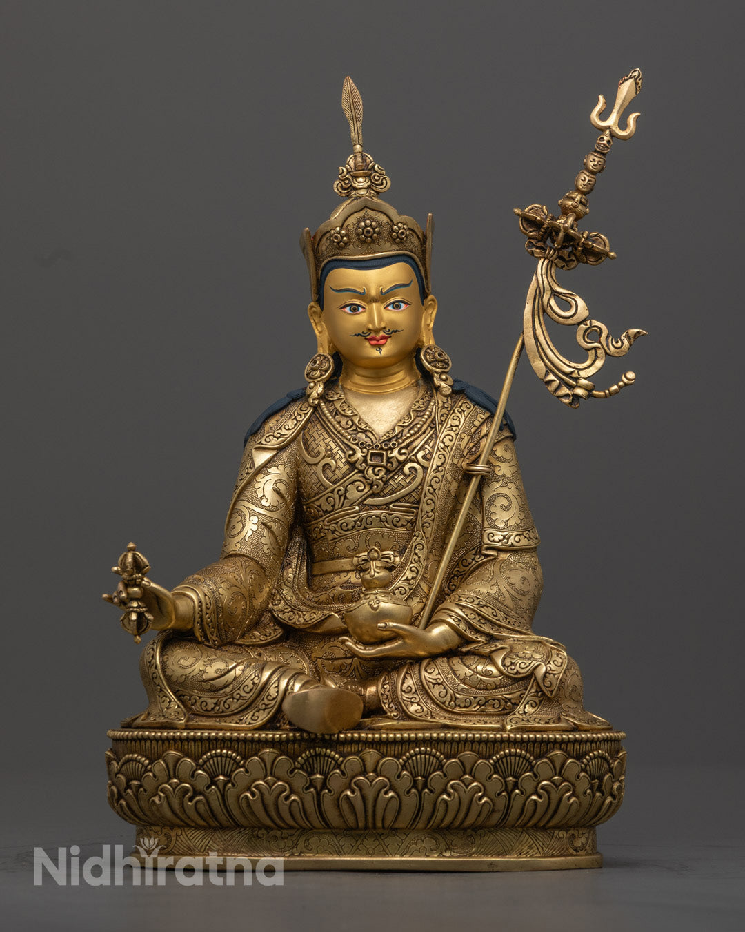 Guru Rinpoche statue made from 24K gold-gilded copper, featuring gold-plated face and vibrant detailing.