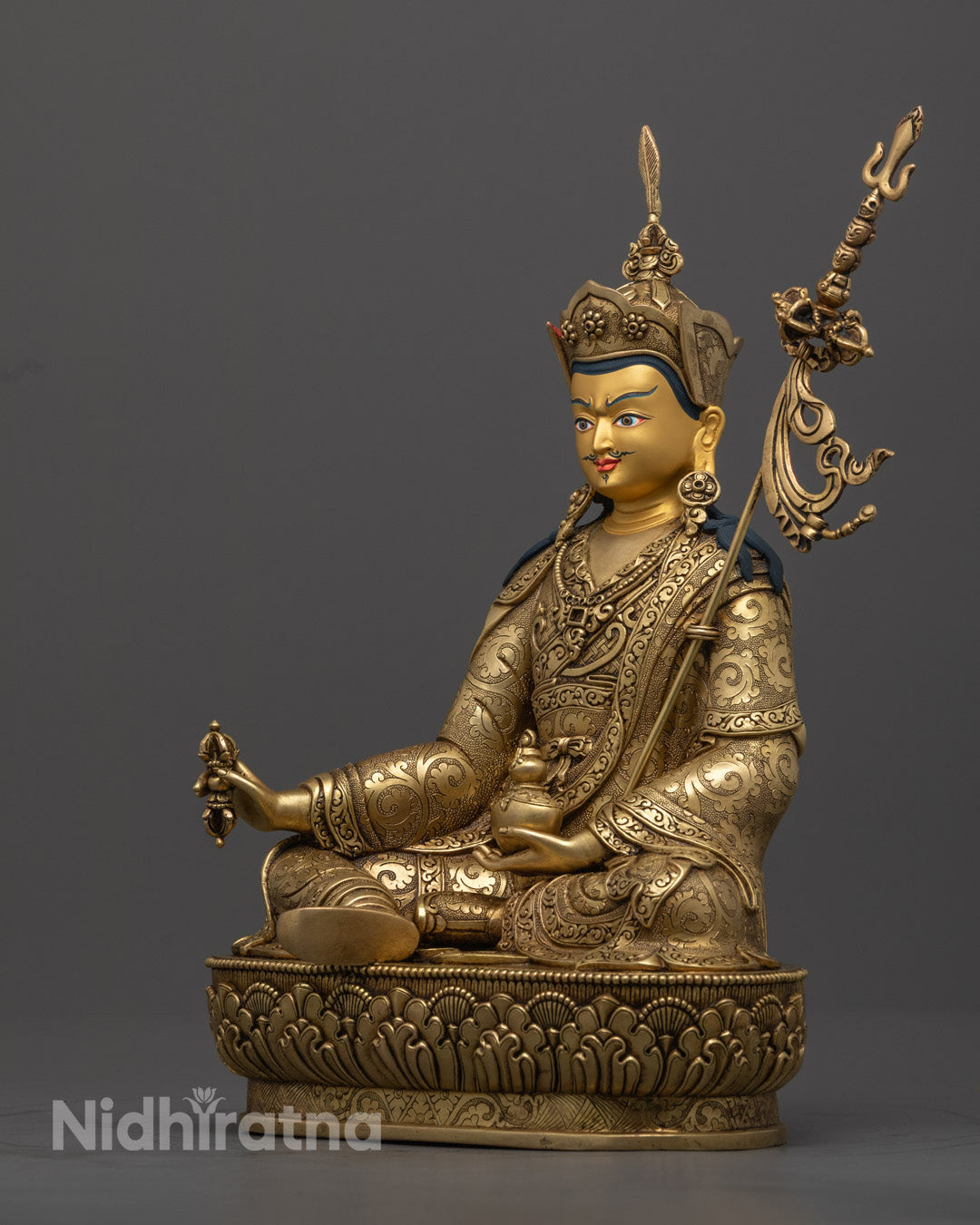 Premium spiritual statue of Guru Rinpoche in lotus posture, handcrafted with 24K gold and traditional artistry.