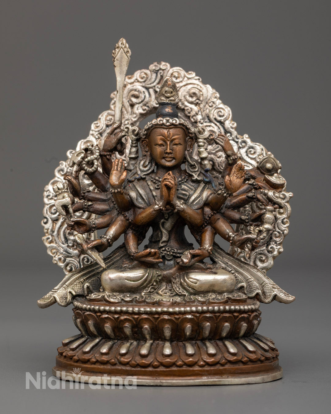 Hand-carved Chundi Devi statue in oxidized copper with intricate details and multiple arms holding sacred symbols.