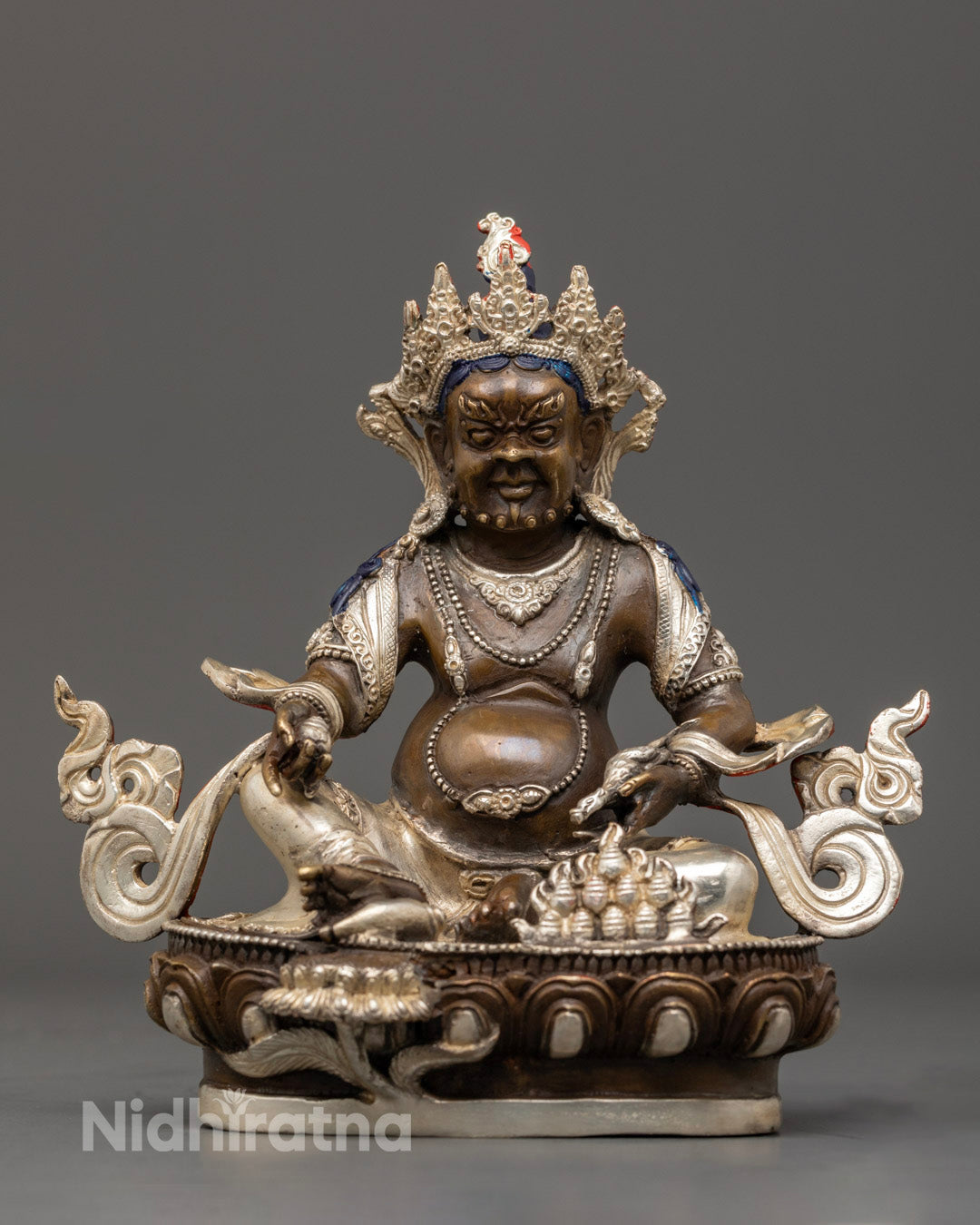 Hand-carved Dzambhala Statue in oxidized copper with silver finish and vibrant acrylic detailing, symbolizing Tibetan deity of wealth and prosperity.
