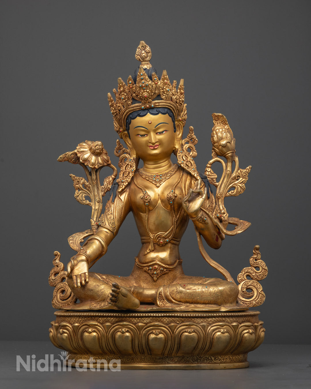 Hand-carved Green Tara Sculpture in 24k gold fire-gilded copper with vibrant multi-colored acrylic details, crafted by Nepalese artisans using lost wax method.