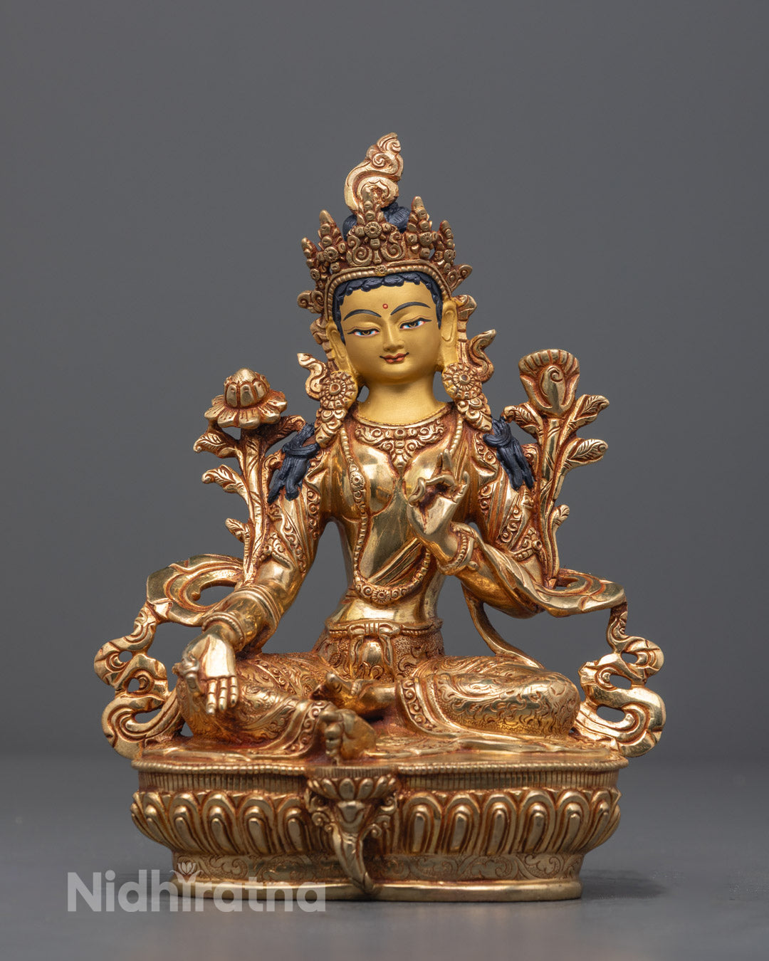 Hand-carved Green Tara statue crafted from copper with 24k fire-gilded gold, showing intricate details and vibrant acrylic colors.