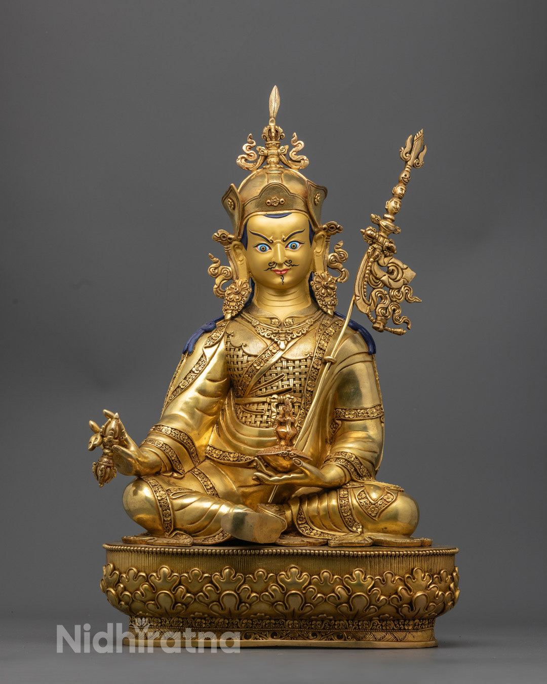 Hand-carved Guru Rinpoche Statue with 24k gold fire-gilded copper and colorful acrylic detailing, crafted in Nepal using lost wax method.
