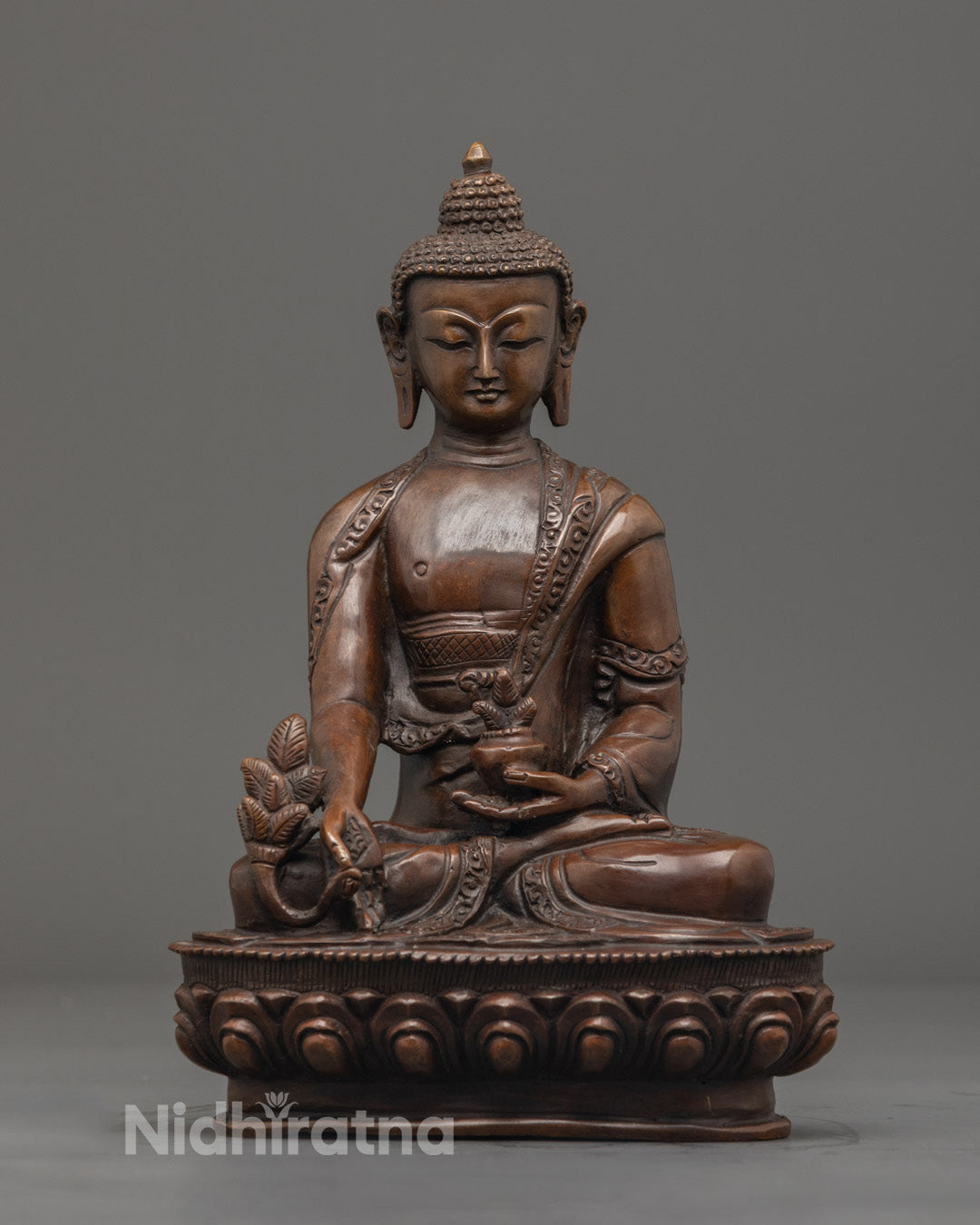 Hand-carved Medicine Buddha statue in oxidized copper with vibrant acrylic colors, seated on a lotus throne with hollow chamber for mantras.