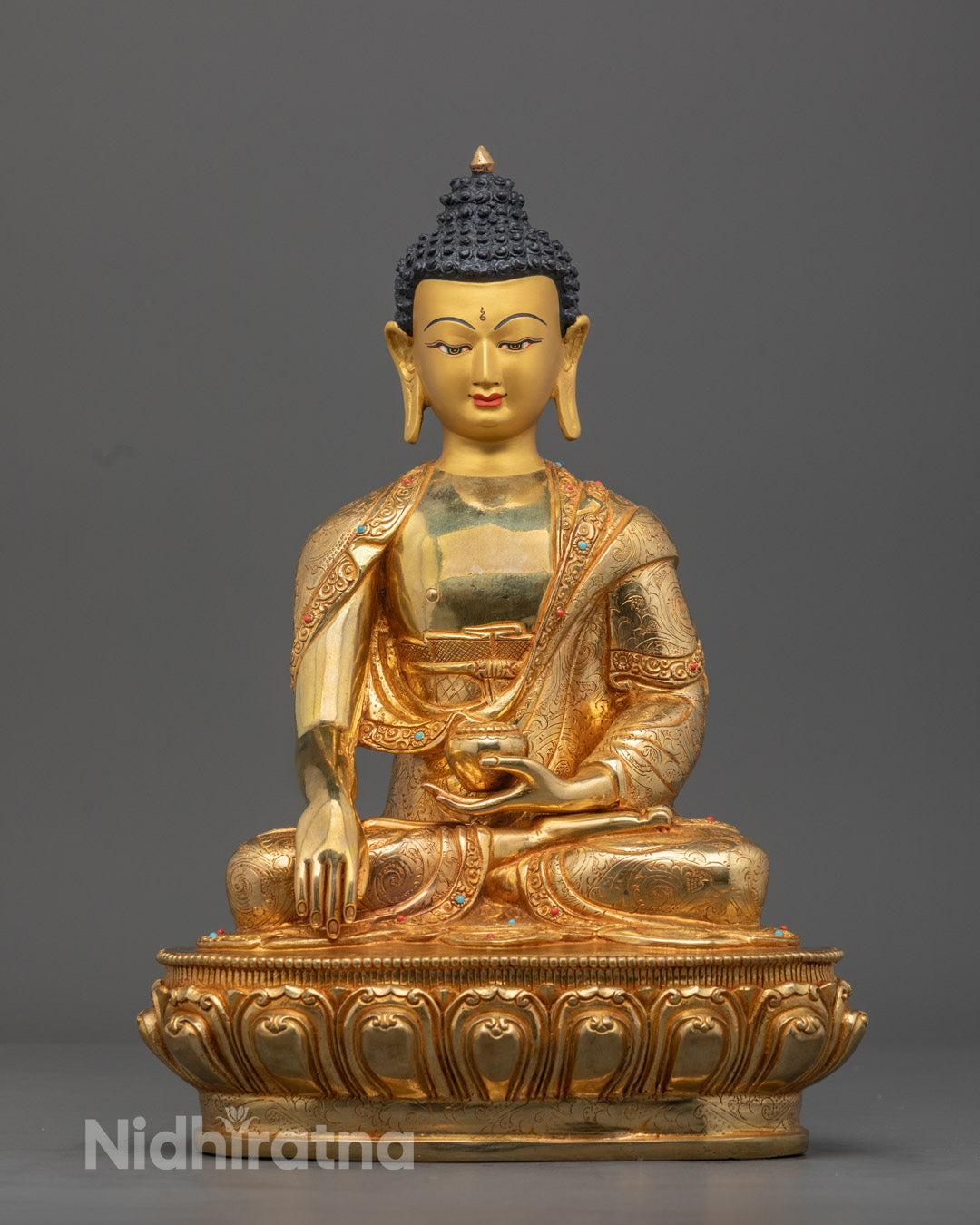 Hand-carved Shakyamuni Buddha statue with 24k gold fire-gilding and semi-precious stones, crafted using the traditional lost wax method in Nepal.