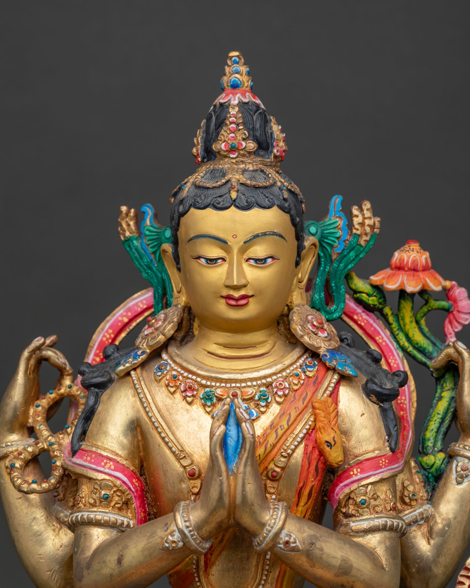Handcrafted Nepalese Four-Armed Chenrezig Statue with gold-painted face.