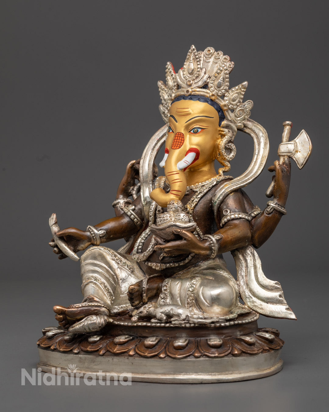 Handcrafted Ganesh statue on display altar with gold-plated finish, holding axe, mala, and sweet bowl
