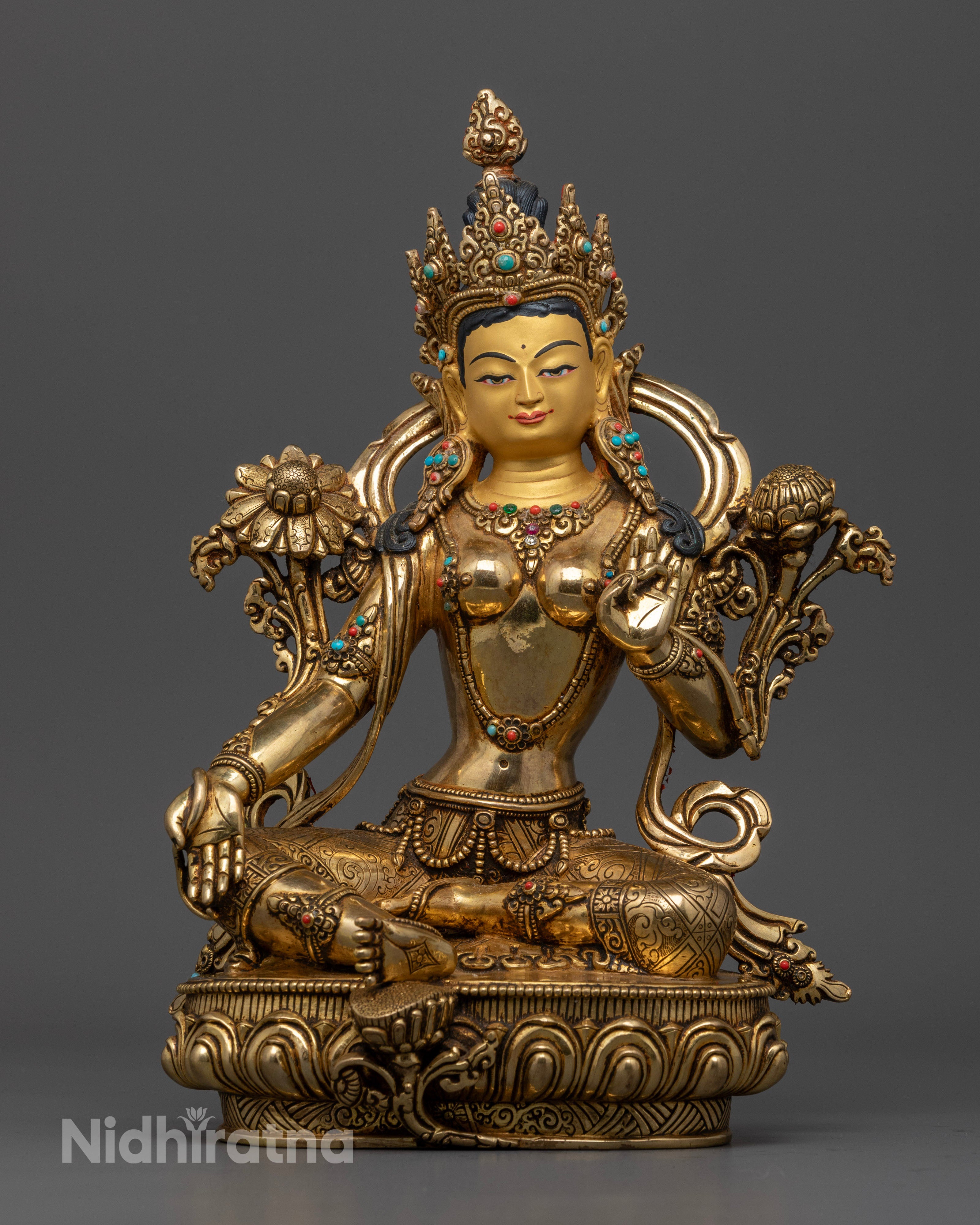 Handcrafted Green Tara statue from Patan, Nepal, featuring a 24k gold-plated face, vibrant acrylic colors, and semi-precious stone adornments, standing 29.5cm tall.