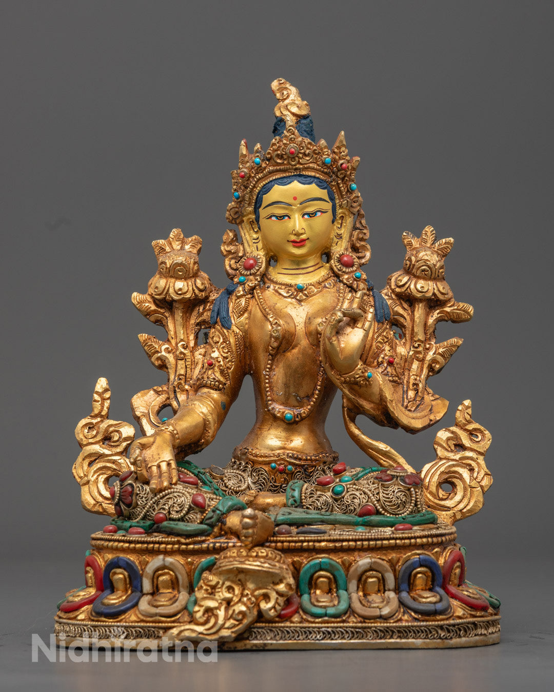 Handcrafted Green Tara statue with 24k gold-gilded face and old fire gold-gilded alloy body, adorned with turquoise, coral, and lapis lazuli stones, seated on a lotus throne.