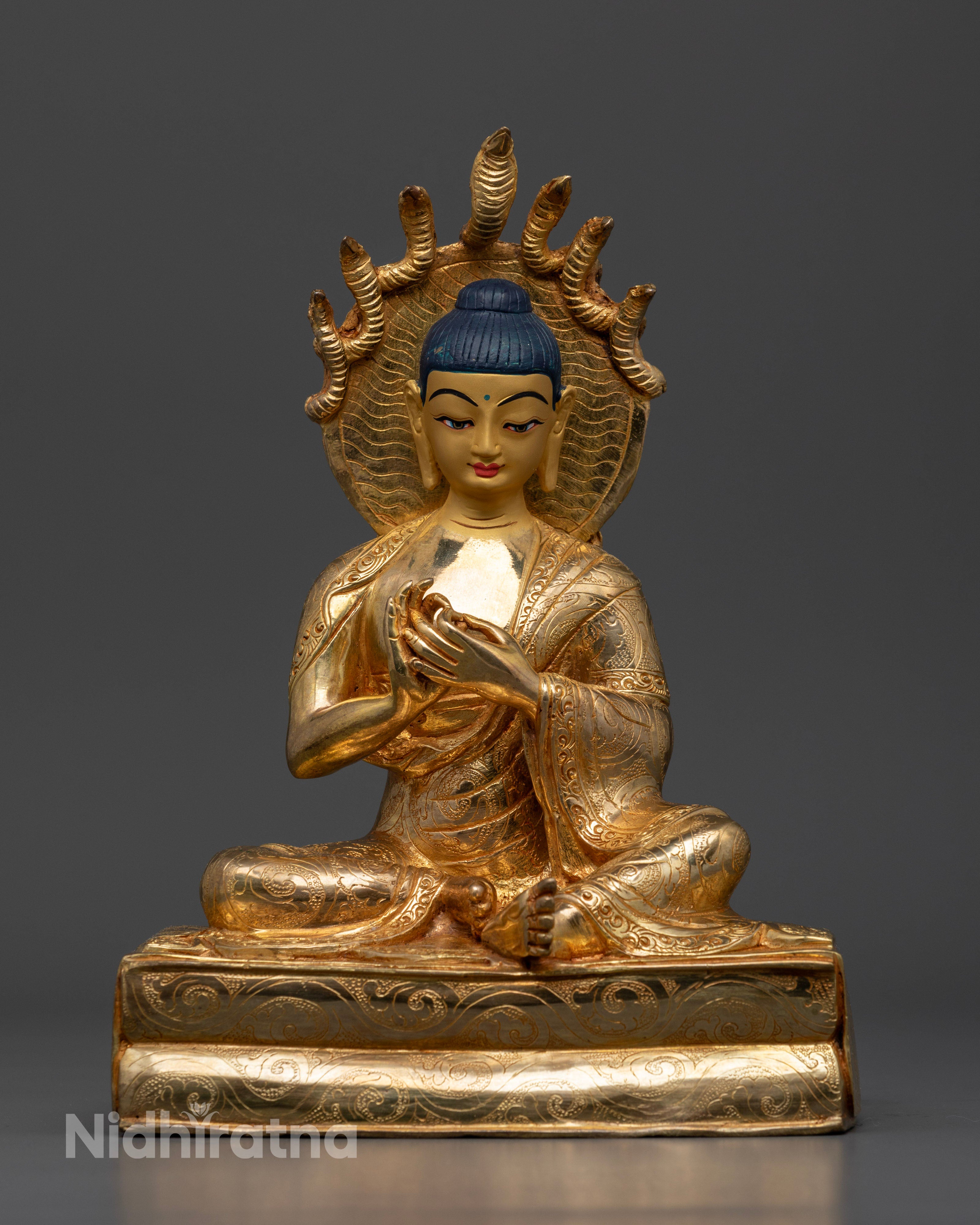 Handcrafted Nagarjuna statue from Patan, Nepal, made of high-quality copper with a radiant 24k gold-plated face, adorned with semi-precious stones and vibrant acrylic colors.