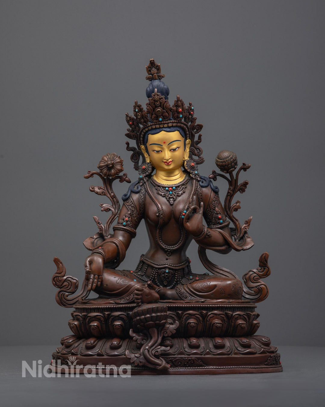 Handcrafted Oxidized Green Tara Statue with 24K gold-gilded face, seated in Lalitasana on a lotus throne, displaying Varada Mudra.