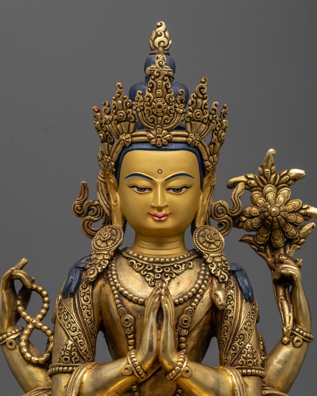 Handcrafted Tibetan Chenrezig statue seated on lotus throne, holding mala in right hand and utpala flower with wish-fulfilling gem in left hand