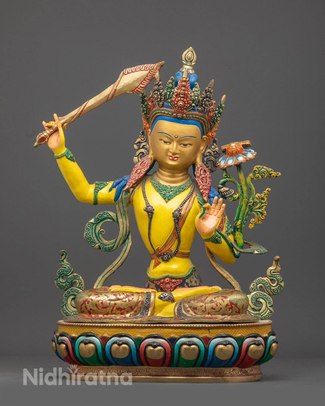 Handcrafted Yellow Manjushri statue seated on lotus throne, holding flaming wisdom sword and Prajnaparamita scripture, with intricate gold-accented details on oxidized copper