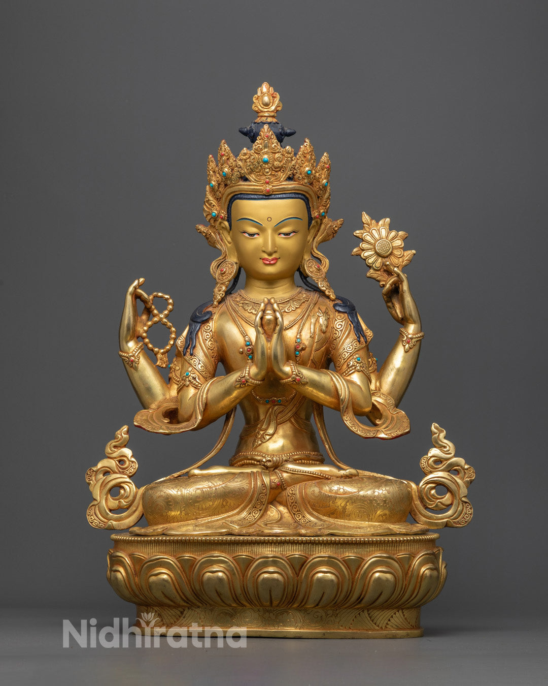 Handmade Chenrezig statue from Nepal with gold-gilded face and intricate carvings on floating robe and crown
