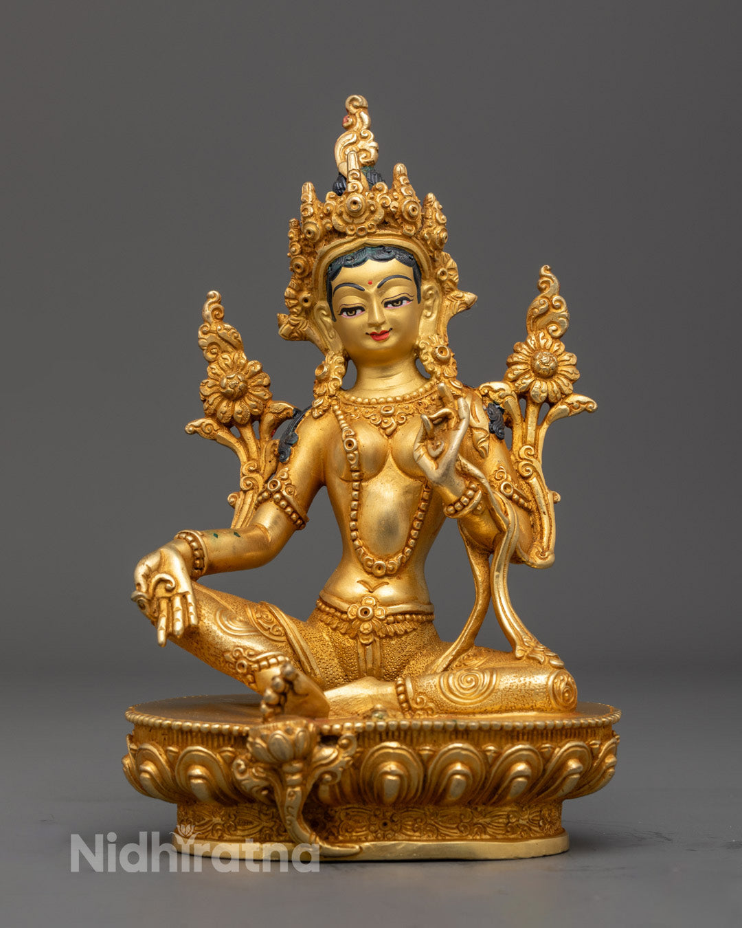 Handmade Green Tara Statue with 24k gold gilding and vibrant acrylic colors, crafted by Nepali artisan using lost wax method.