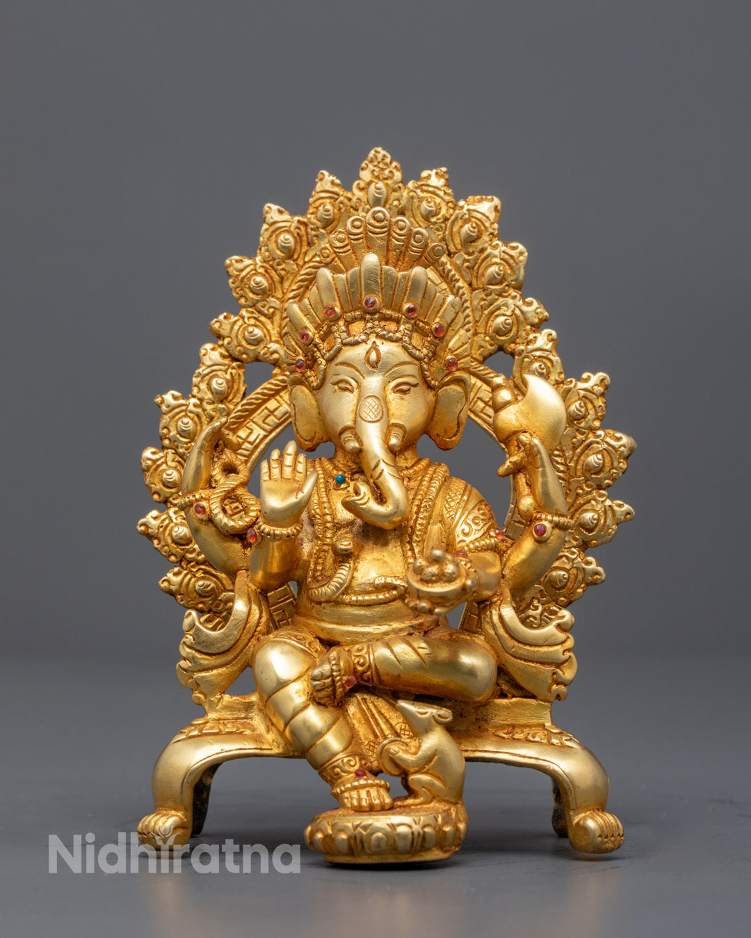 Handmade Lord Ganesha statue with gold-gilded face and fire-gilded body seated on floral throne – spiritual Hindu decor for home altar