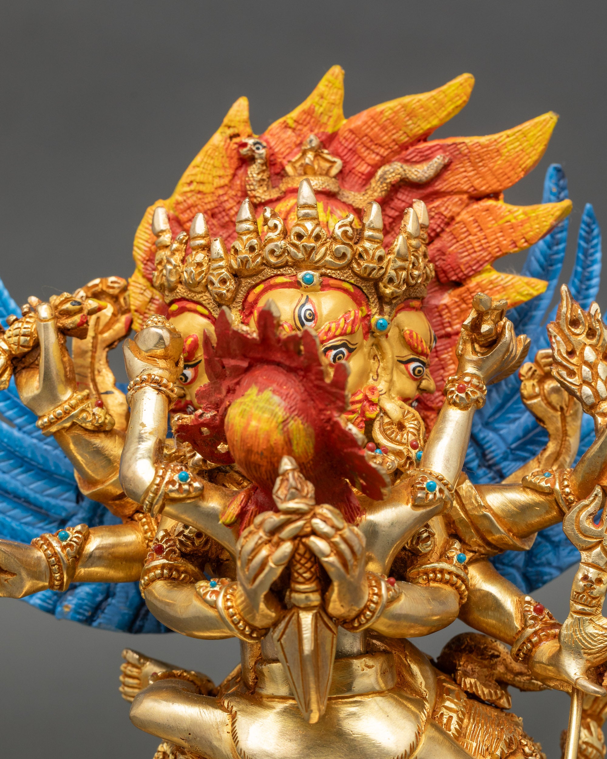 Hayagriva statue close-up with intricate fire-gilded gold and detailed wings