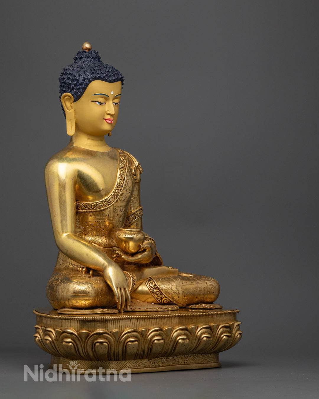 High-relief carvings on the sanghati (monastic robe) of Shakyamuni Buddha statue showcasing intricate craftsmanship.