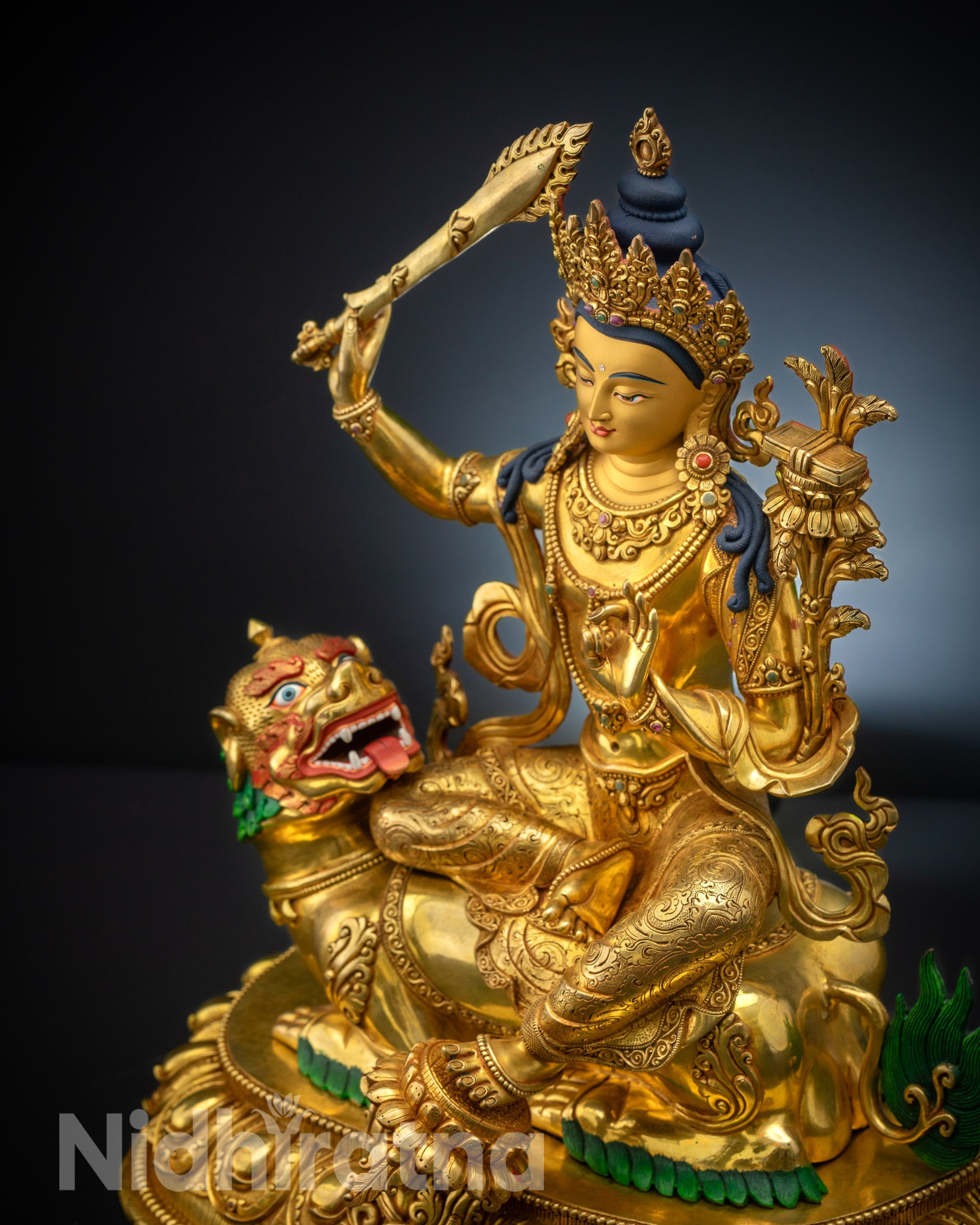 High-angle view of Handicrafted Simhada Manjushri Statue seated on a roaring lion, showcasing gold-gilded details